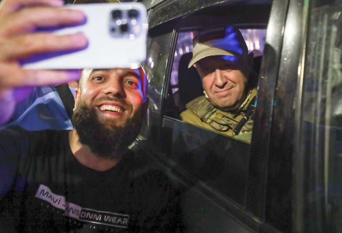 Yevgeny Prigozhin sits inside a military vehicle posing for a selfie photo with a local civilian on a street in Rostov-on-Don, Russia, on Saturday. Photo / AP