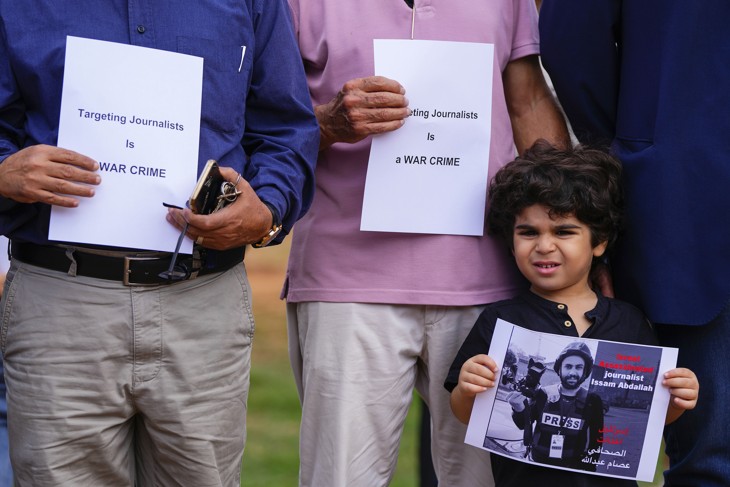 A boy holds a portrait of Reuters videographer Issam Abdallah during a protest in Beirut, Lebanon. Abdallah was killed when an Israeli shell landed in a gathering of international journalists covering clashes on the border. Photo / AP