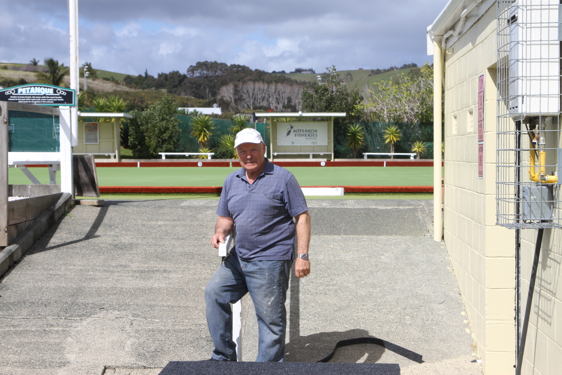 Jim Naylor enjoys a moment in the sun at Coopers Beach Bowling Club on Friday before moving on to his next job.