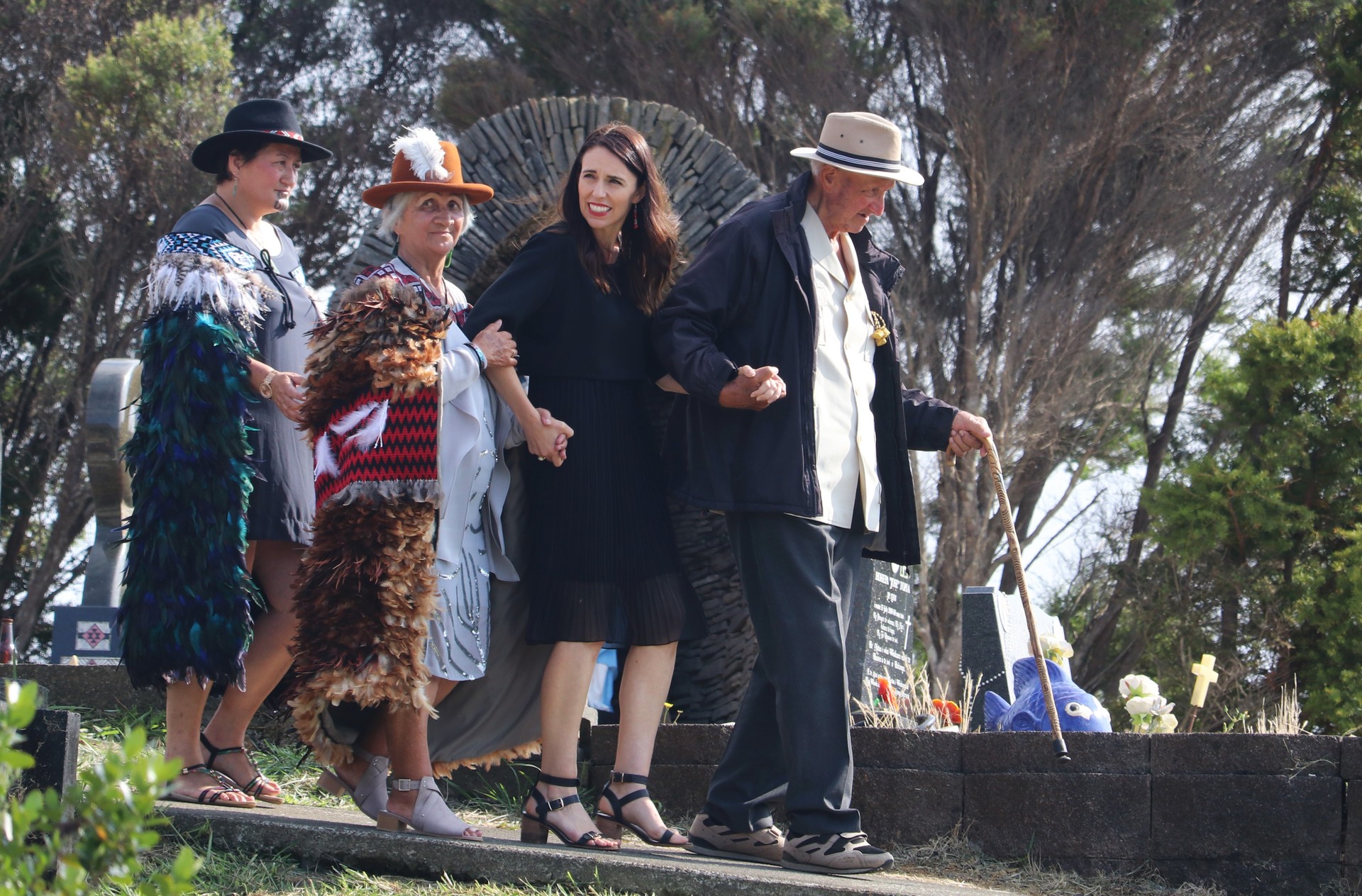 Dame Whina Cooper's daughter Hine Cooper and son Joe Cooper escort Prime Minister Jacinda Ardern through the urupa where the famous kuia is buried. Photo / Peter de Graaf