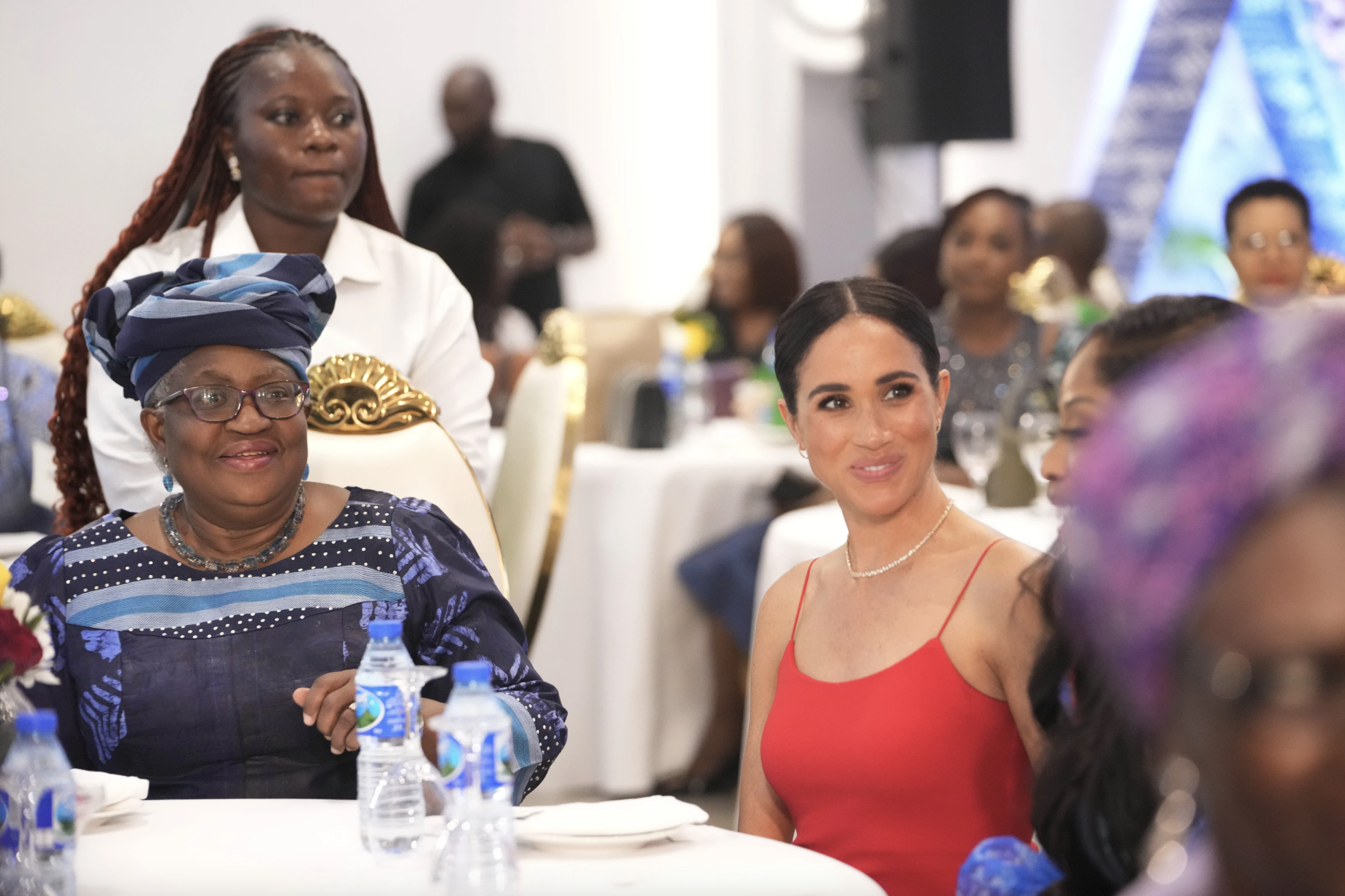 Meghan, the Duchess of Sussex sits by Ngoni Okonjo-Iweala, director-general of the World Trade Organisation, doing an event in Abuja, Nigeria on Saturday. Photo / AP