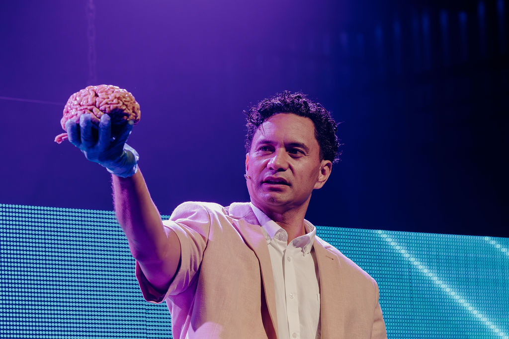 Dr Toby Sealey holds a human brain. He's played by Jarod Rawiri.