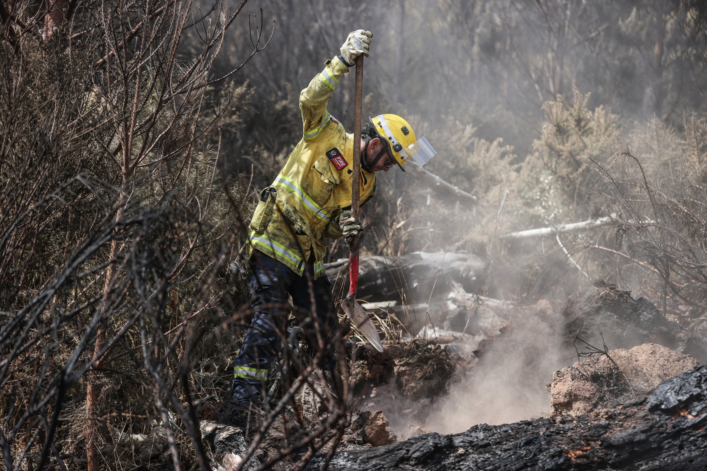 Lee Reihana and other firefighters continue their efforts to dampen down remaining hot spots. Photo / Chris Skelton
