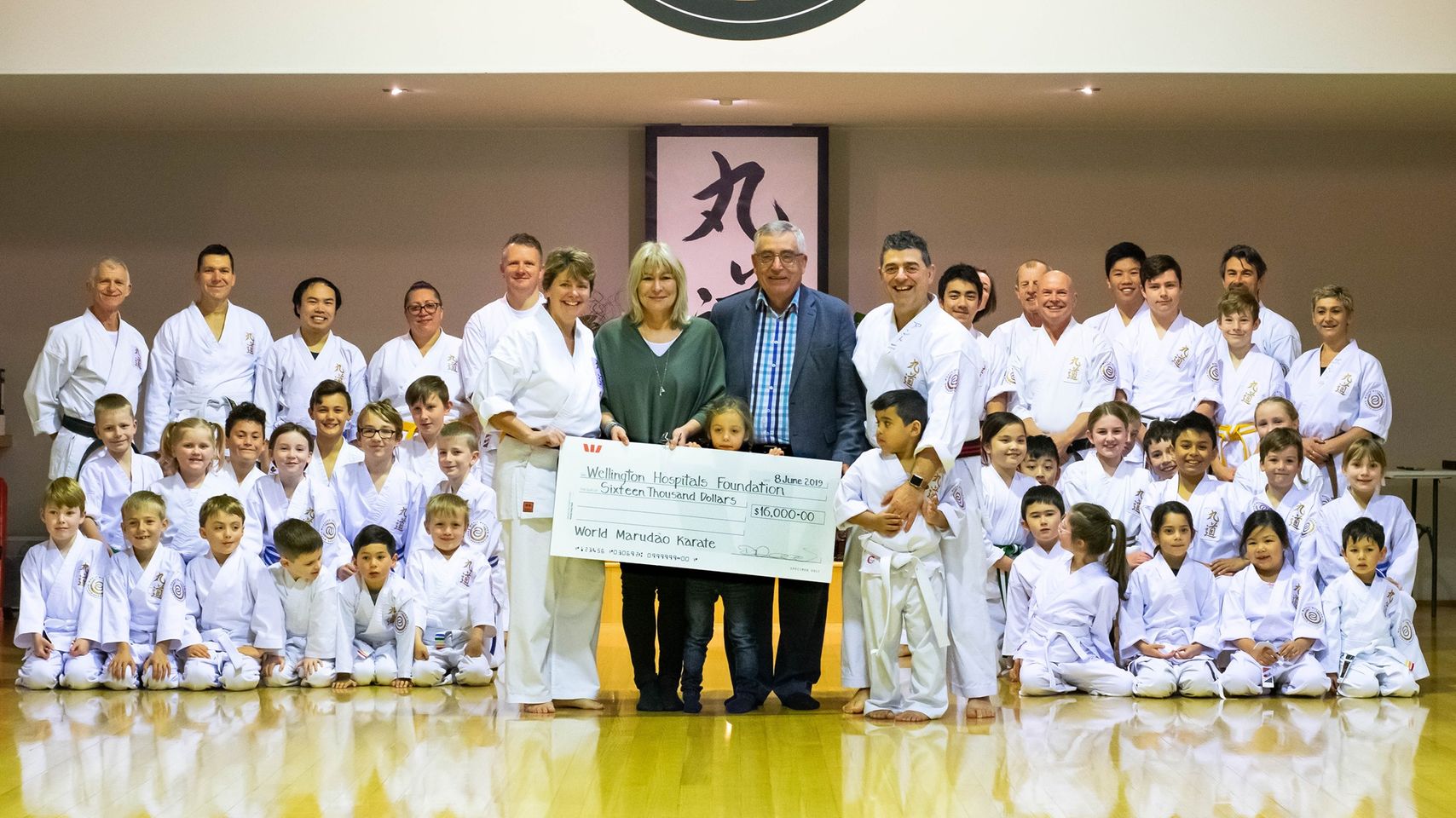 Tony Gaeta and members of his World Marudao Karate dojo hand over the results of their fundraising to the Wellington Hospitals Foundation.