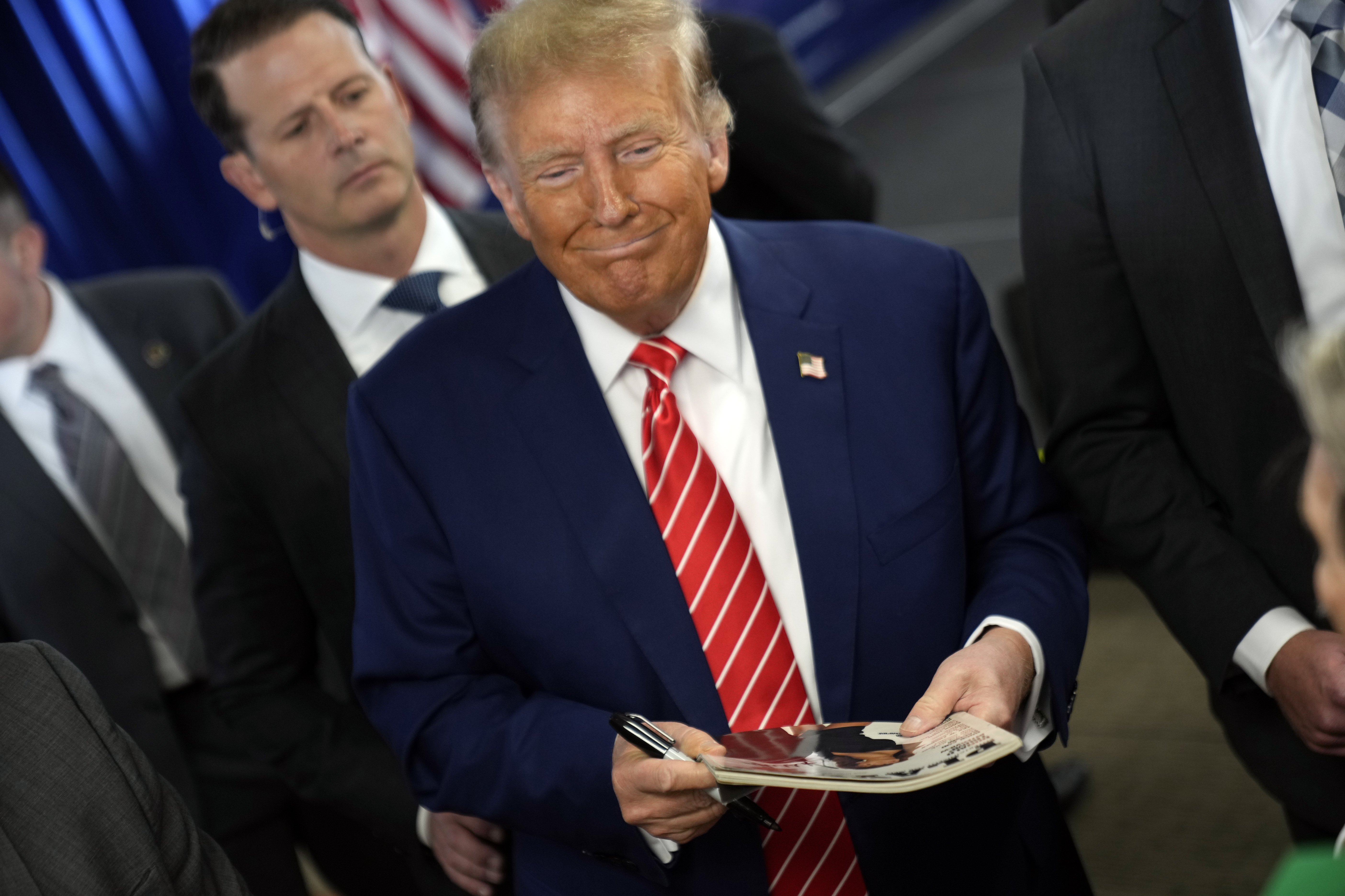 Republican presidential candidate former President Donald Trump signs autographs after speaking at a rally at Des Moines Area Community College in Newton, Iowa. Photo / AP