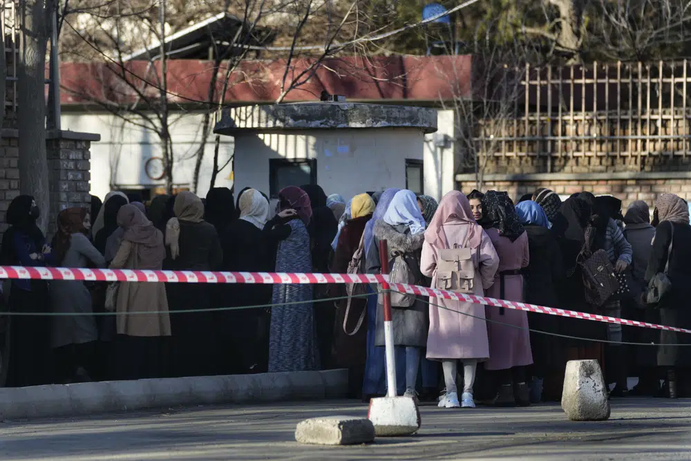 Afghan students queue at one of Kabul University's gates in Kabul, Afghanistan in February 2022. Photo / AP