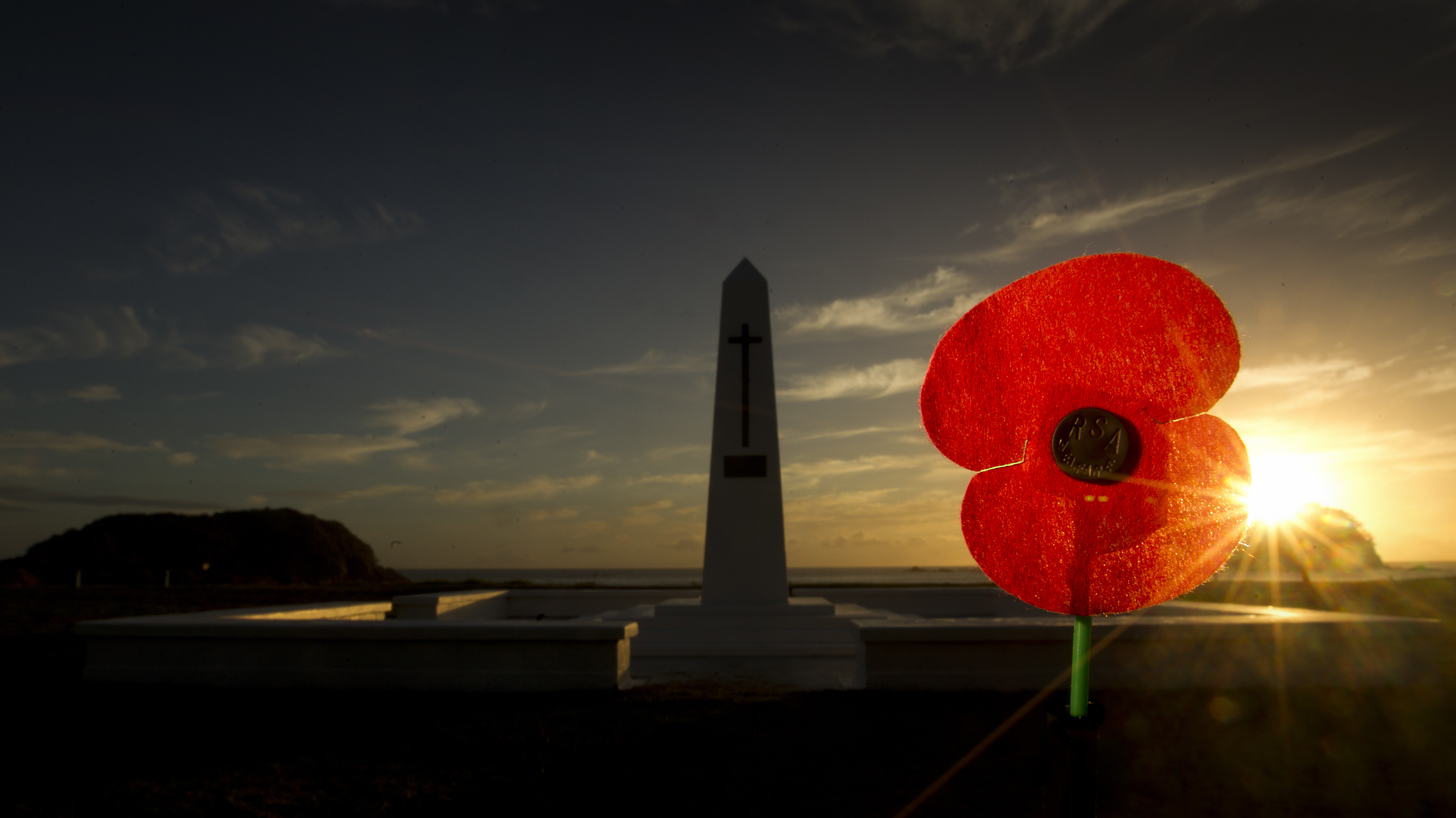 An RSA poppy at dawn in front of the cenotaph at Mt Maunganui.