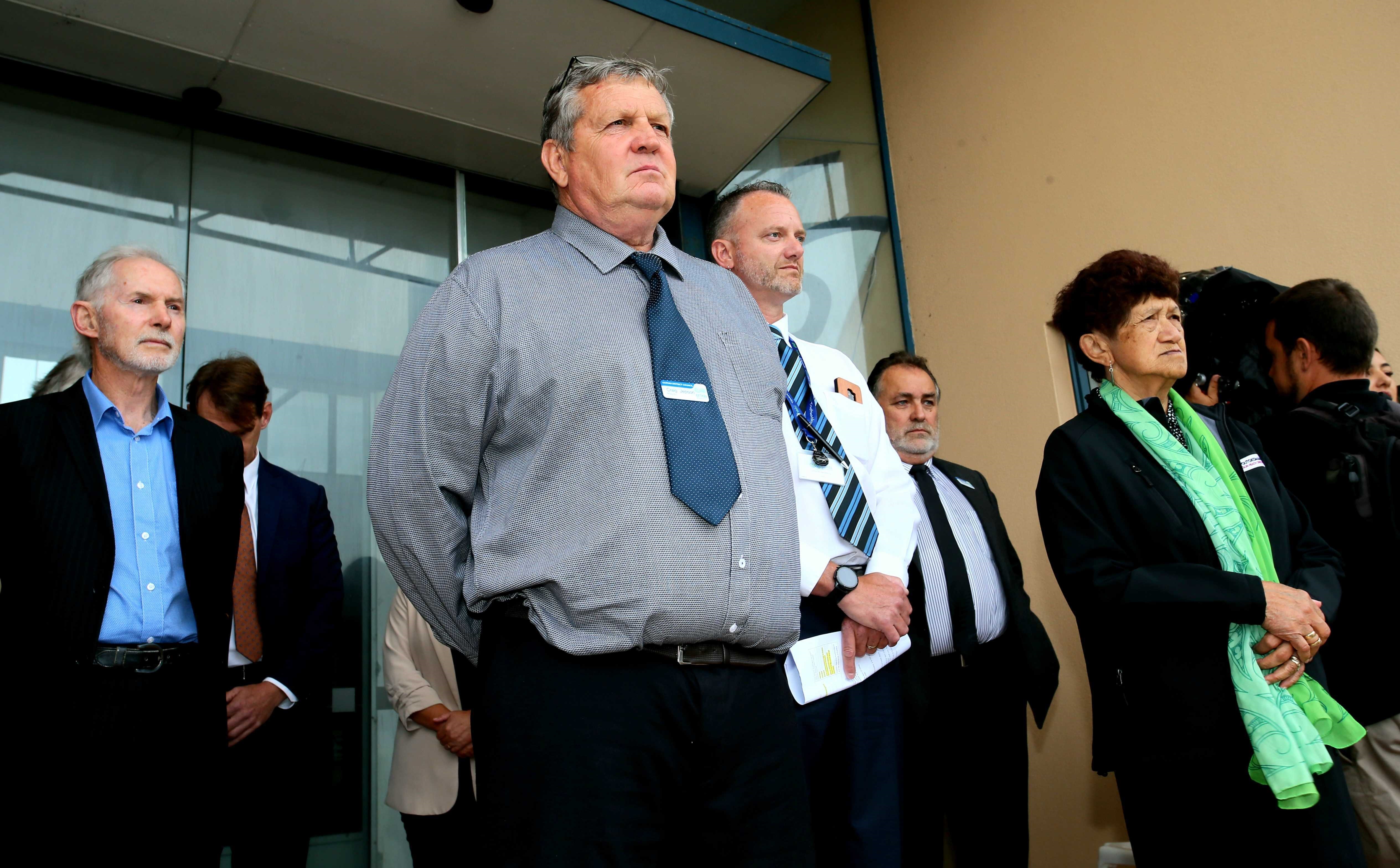 Kaipara Mayor Craig Jepson watches the protest from the steps of Dargaville's town hall. Photo / Tania Whyte