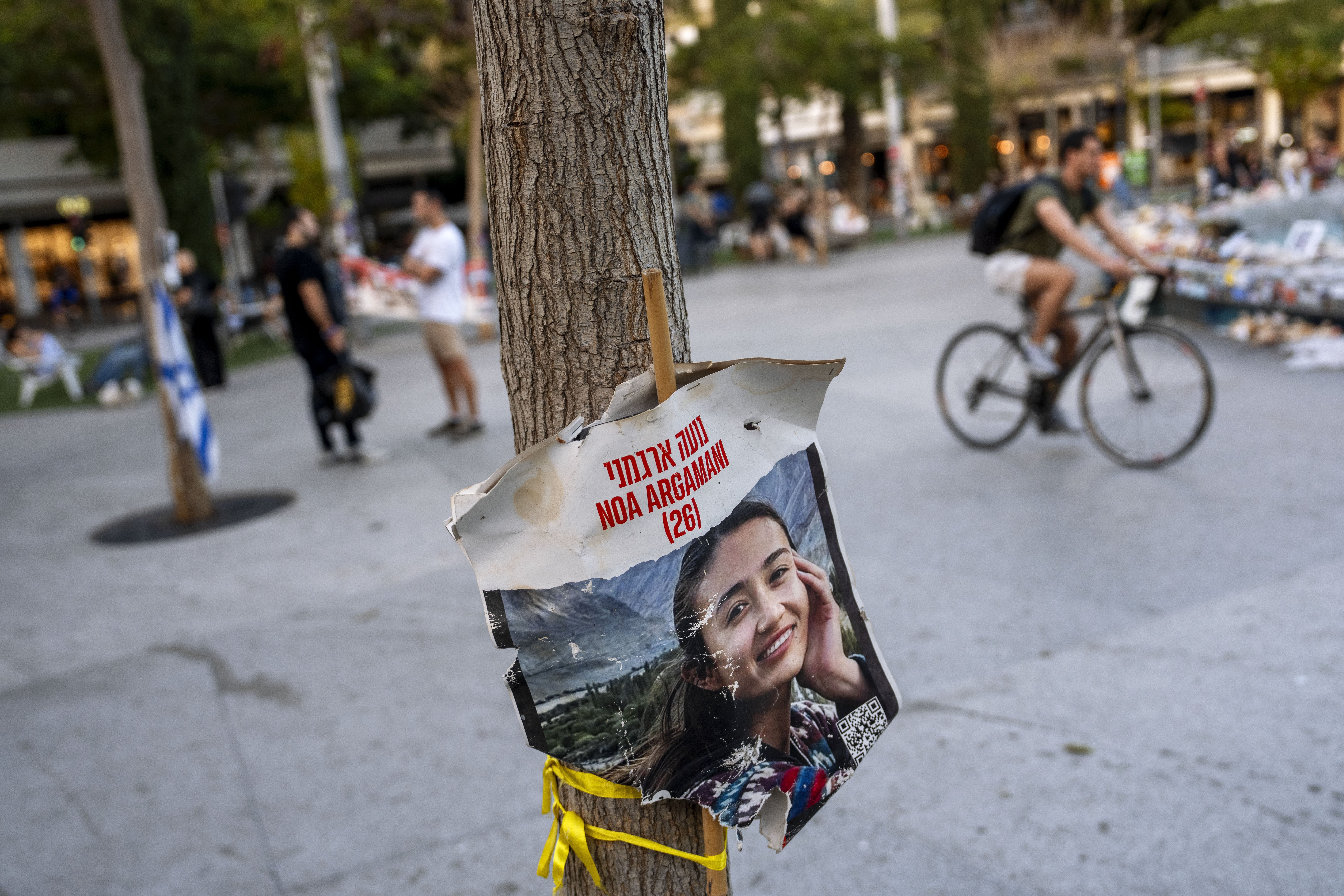 A poster depicting Israeli hostage Noa Argamani, 26, is displayed next to a memorial in Tel Aviv. Photo / AP