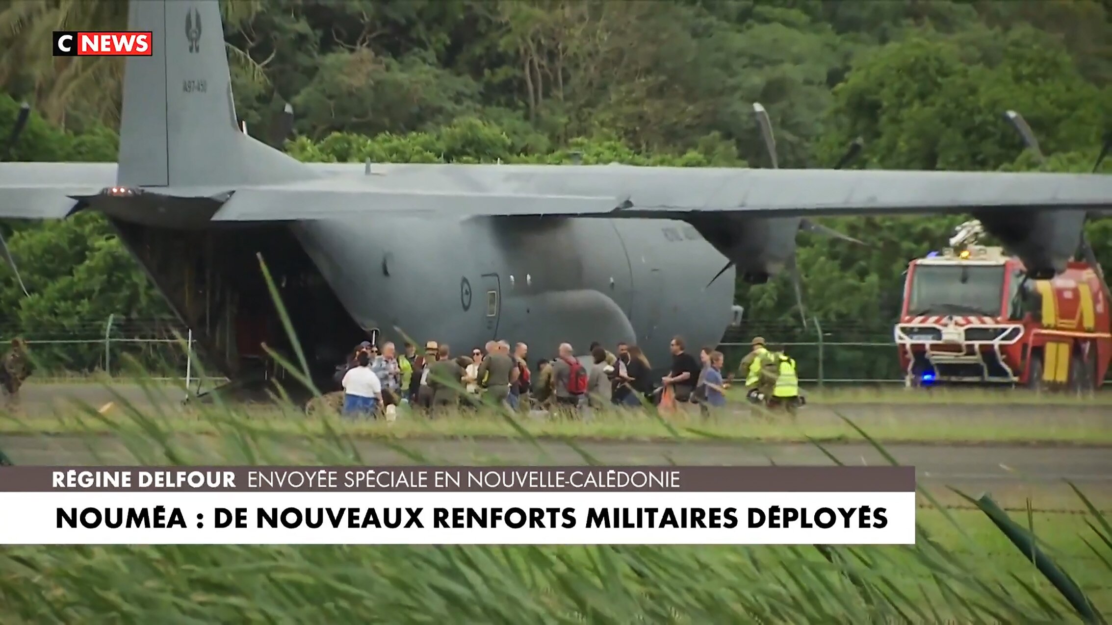A Royal Australian Air Force Hercules at Noumea Magenta Airport, New Caledonia, picking up the first batch of stranded Australian tourists this afternoon. The headline reads: