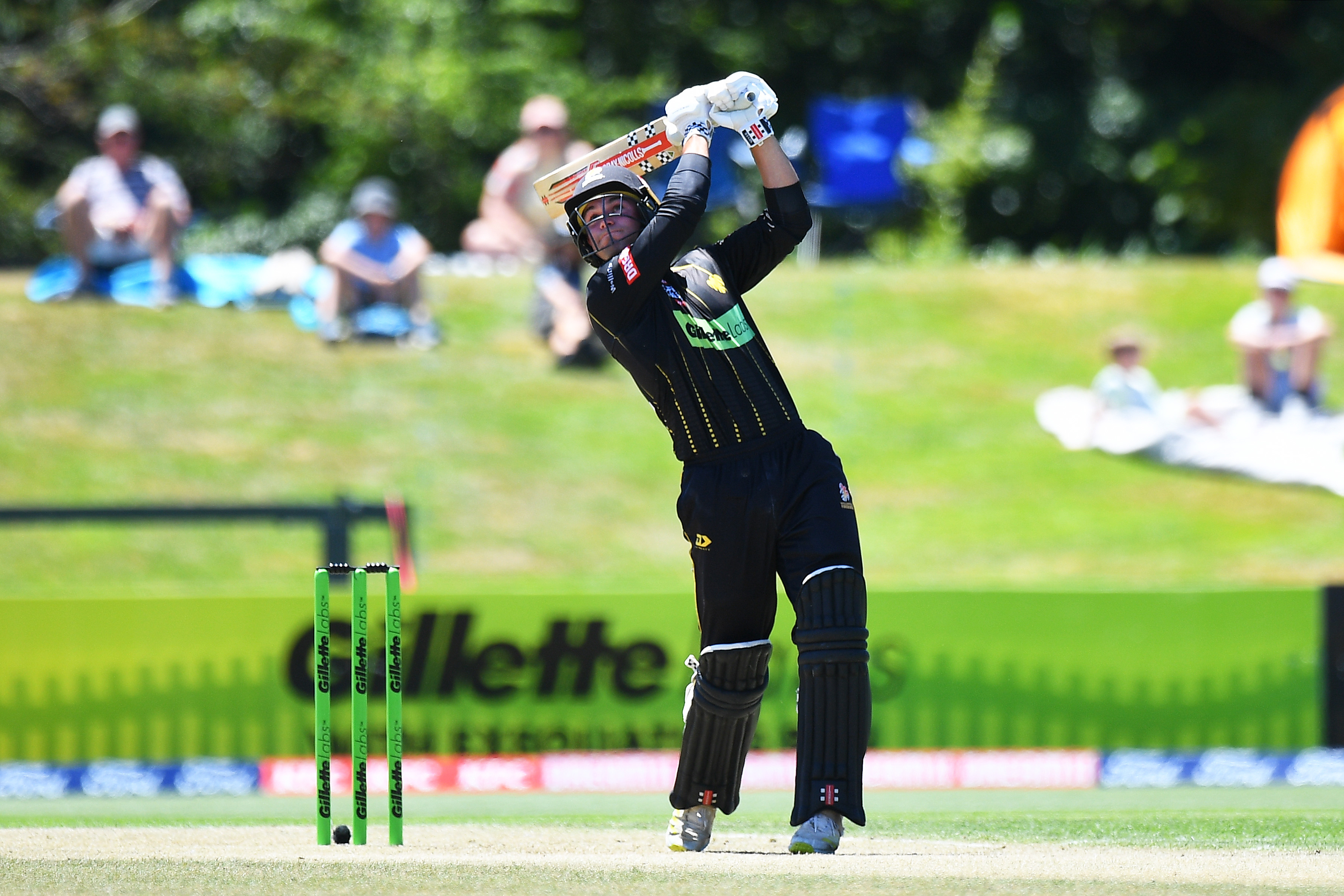 Tim Robinson looks to send another ball over the rope for Wellington. Photo / Photosport