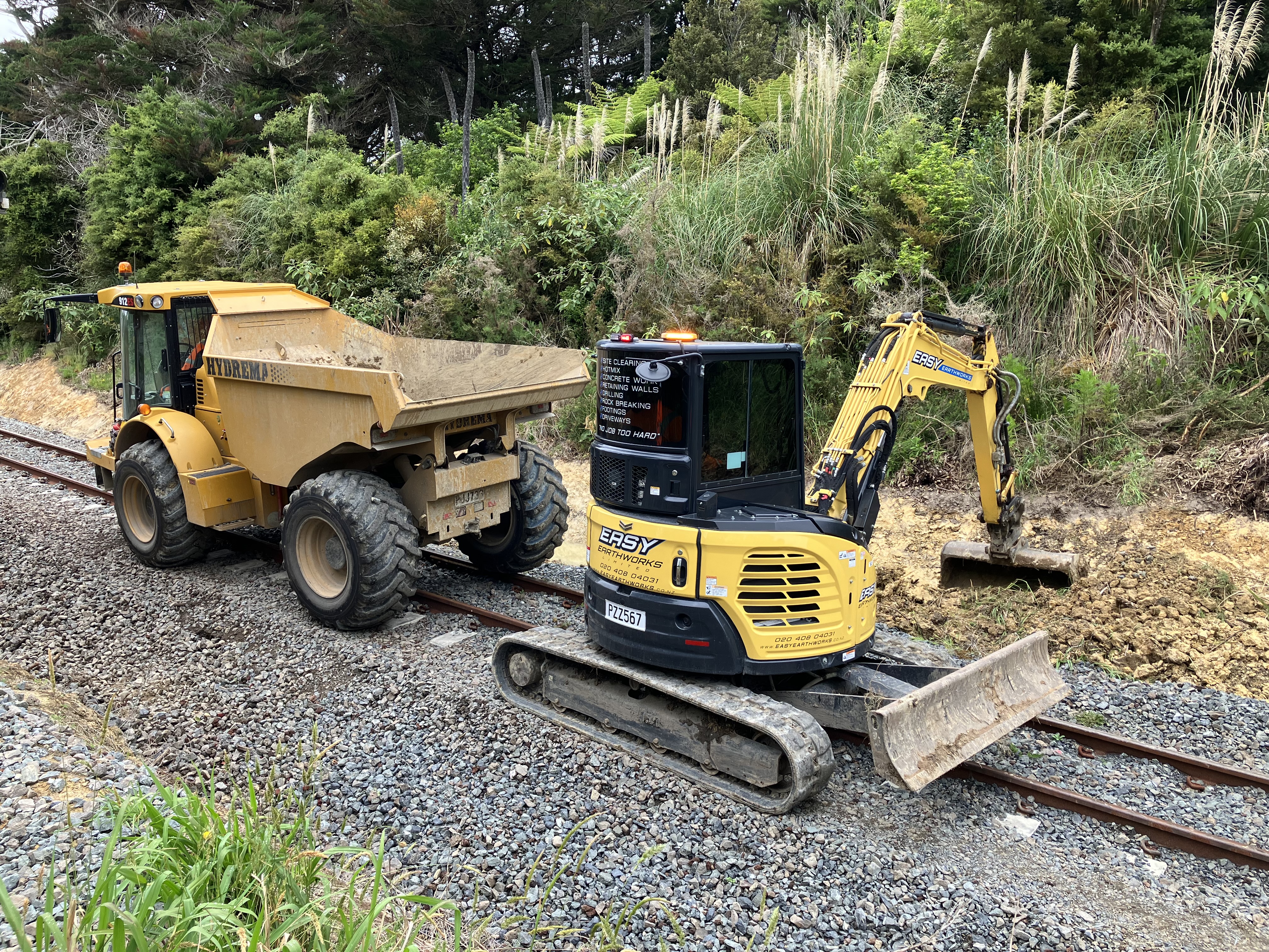 Repair work on the North Auckland Line includes a swale drain being cleared near Maungaturoto.