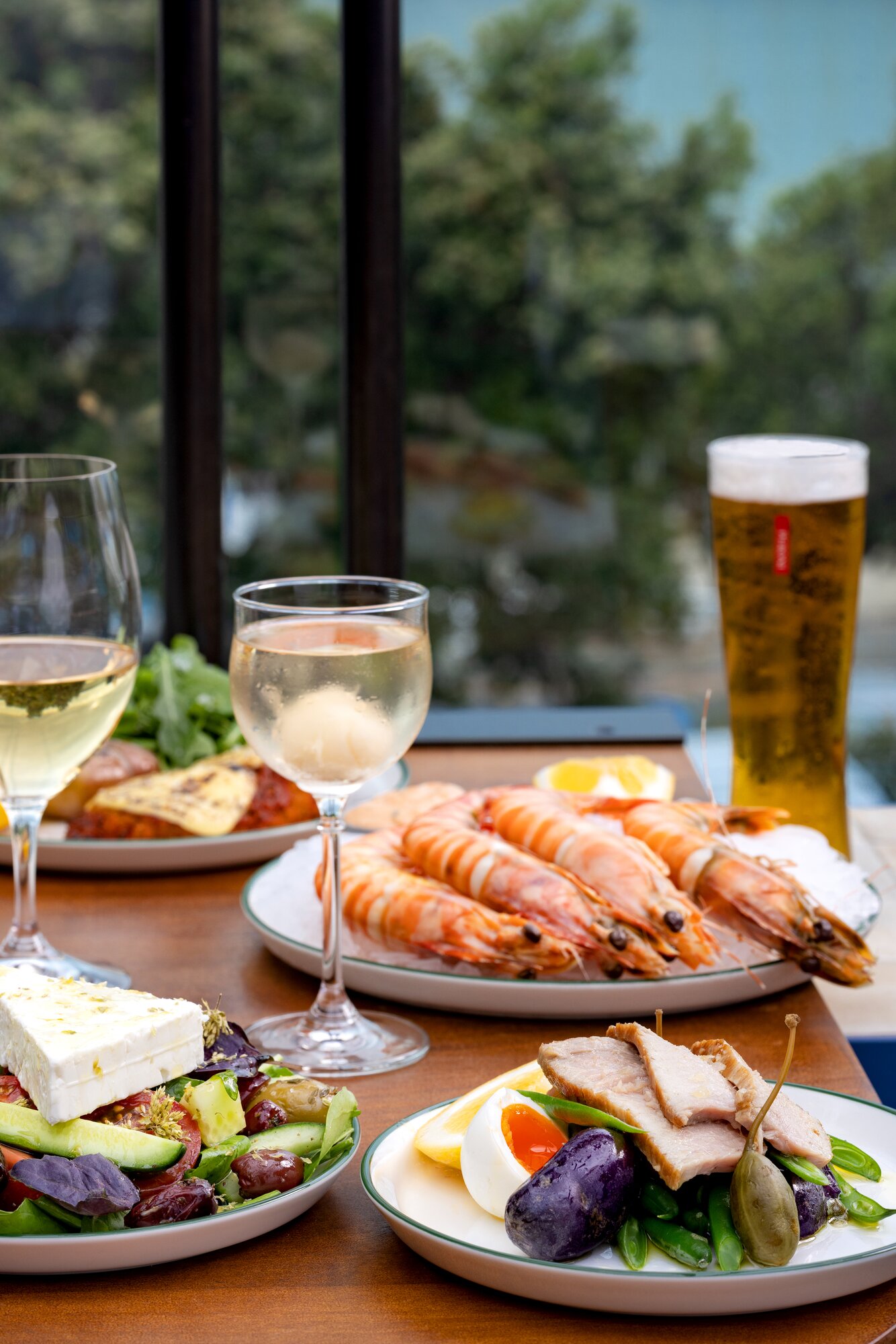 Prawns on ice, a Greek salad and tuna nicoise from Takapuna Surf Club, which is opening soon. Photo / Babiche Martens