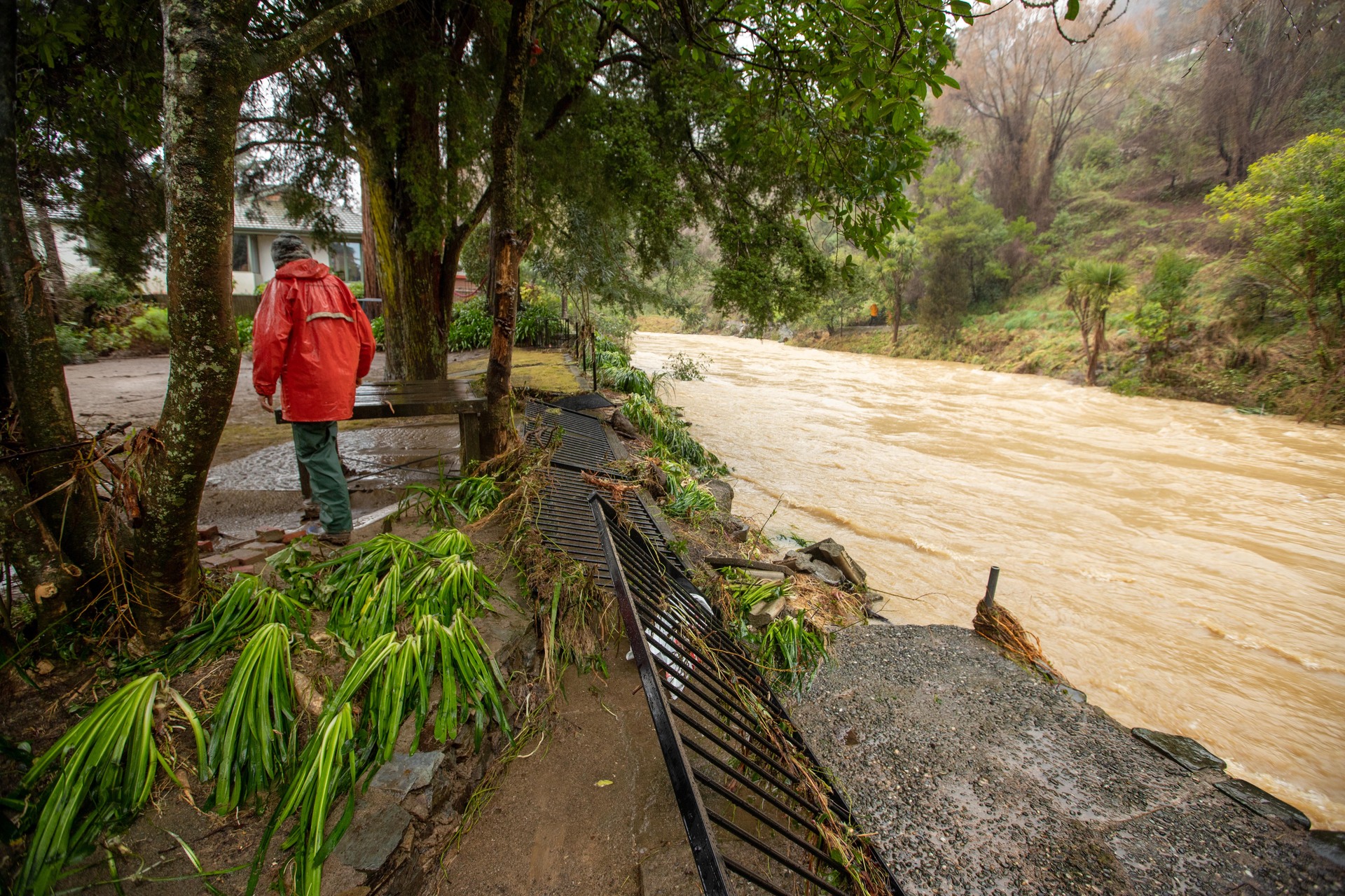 A Nile St, Nelson, resident checks their neighbour's river-side property last month. Photo / Tim Cuff