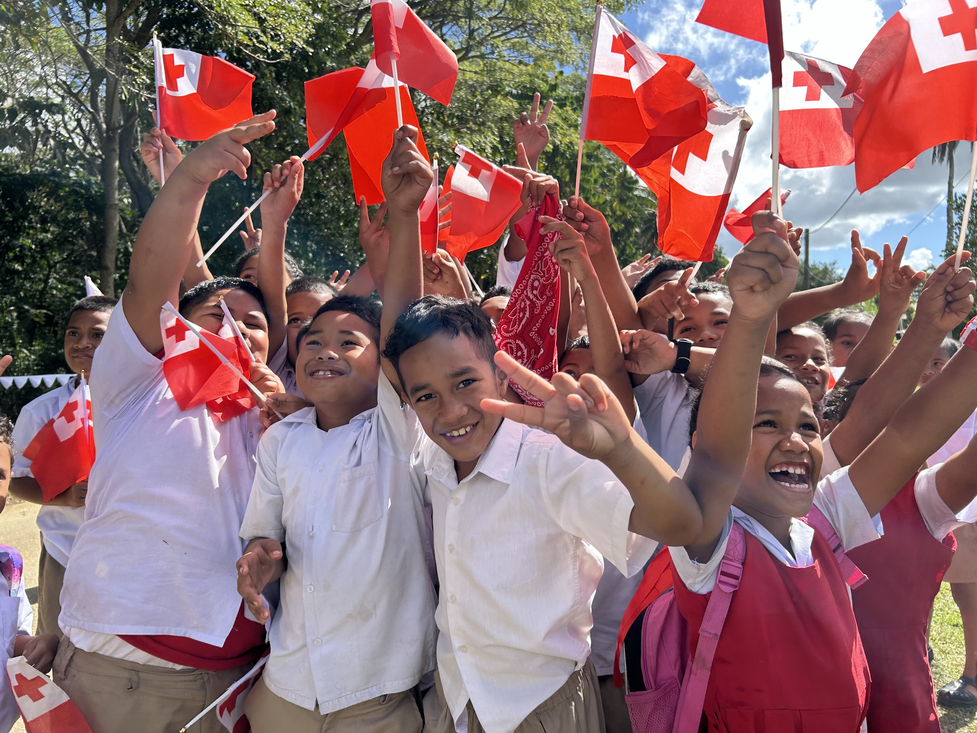 Excited pupils at the Tokomololo Government Middle School in Tonga await Prime Minister Christopher Luxon. Photo / Adam Pearse