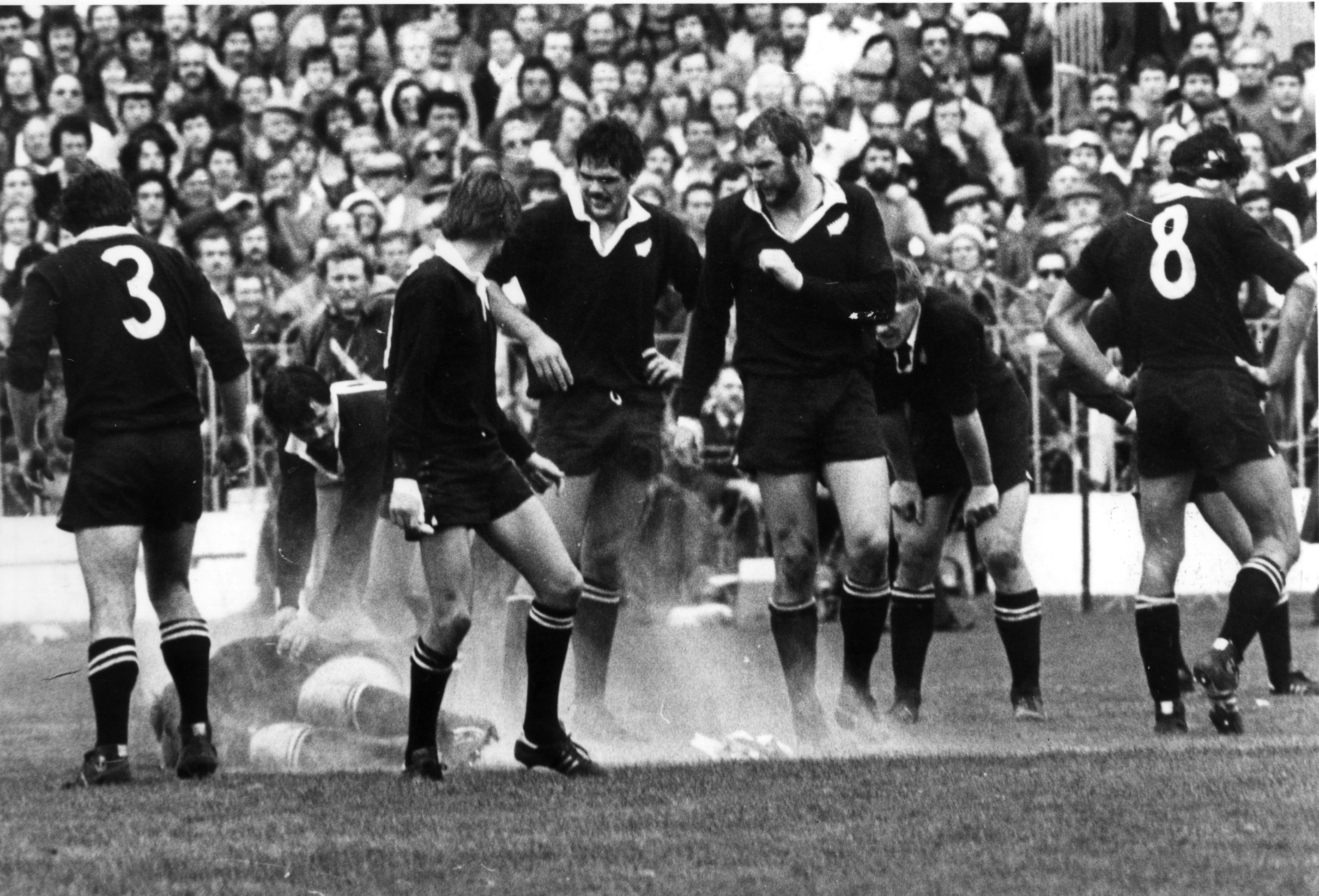 The All Blacks during the third test at Eden Park, where a light aeroplane overhead dropped flour, pamphlets and stink bombs in protest. Photo / NZ Herald