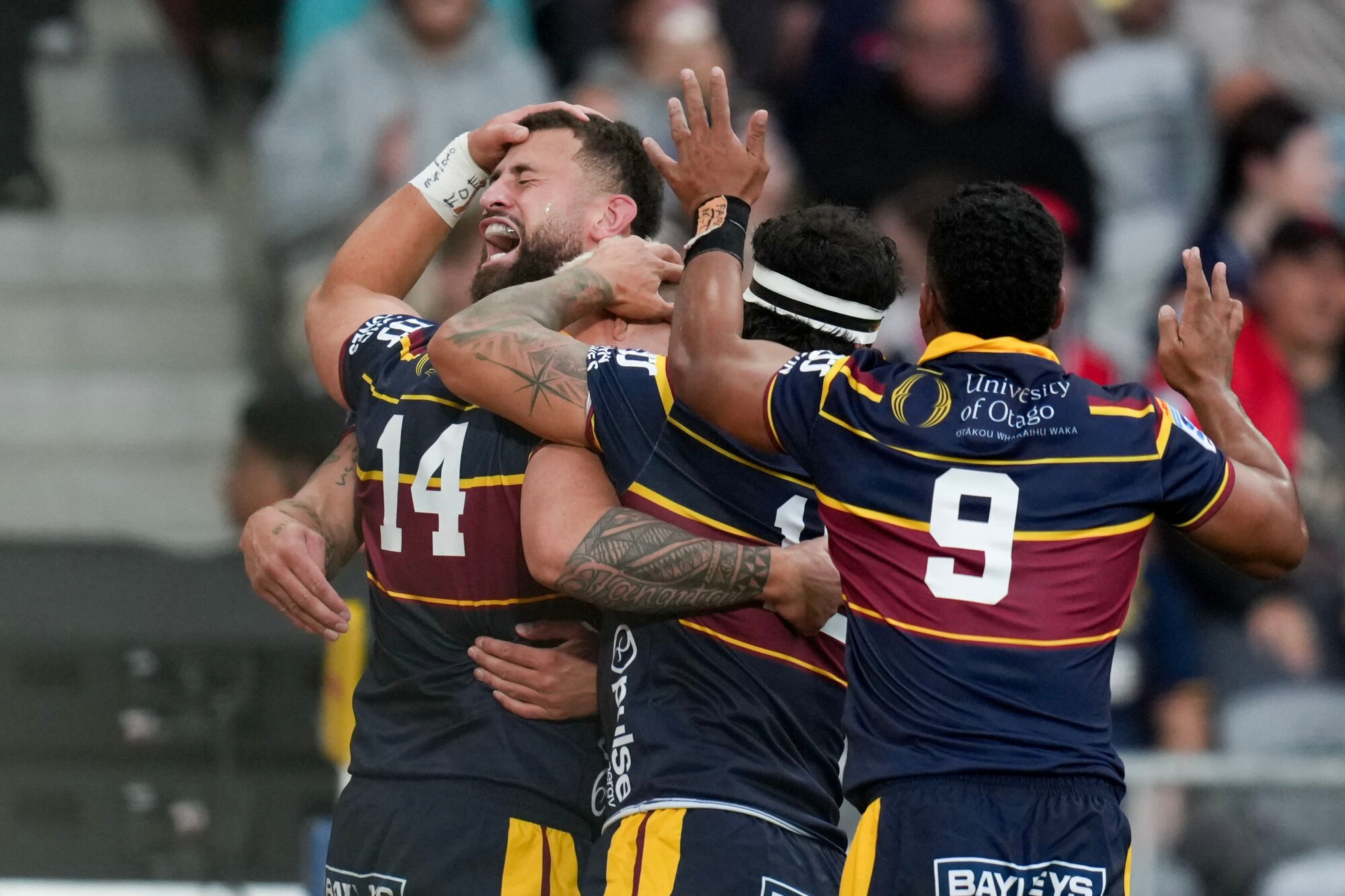 Highlanders players celebrate a try against the Crusaders on Friday night. Photo / Photosport