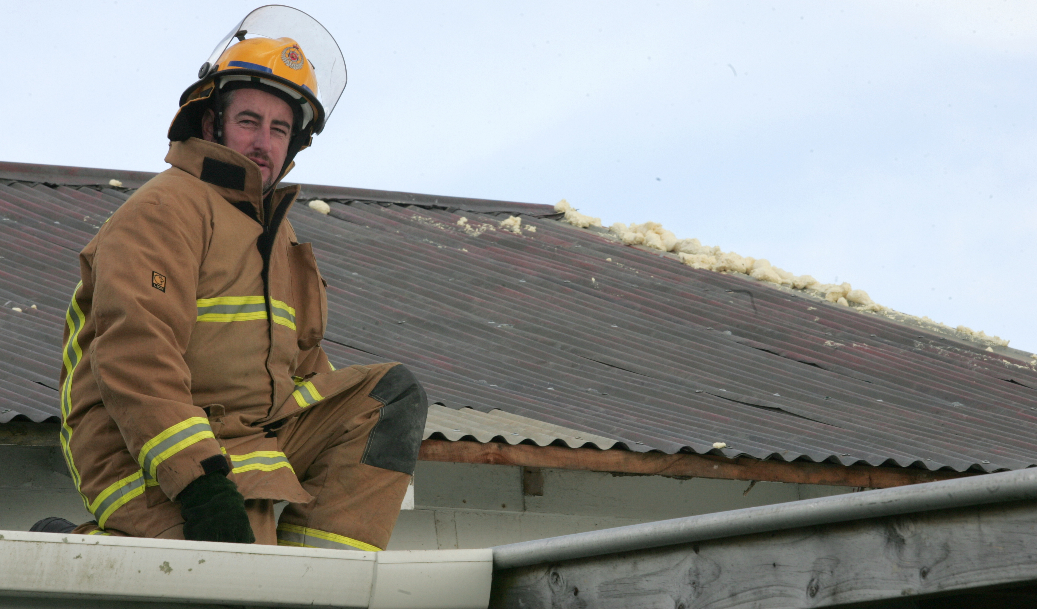 Ruawai Station Officer Anthony Blundell patches up a house hit by a mini-tornado in 2006. Photo/Tania Webb.