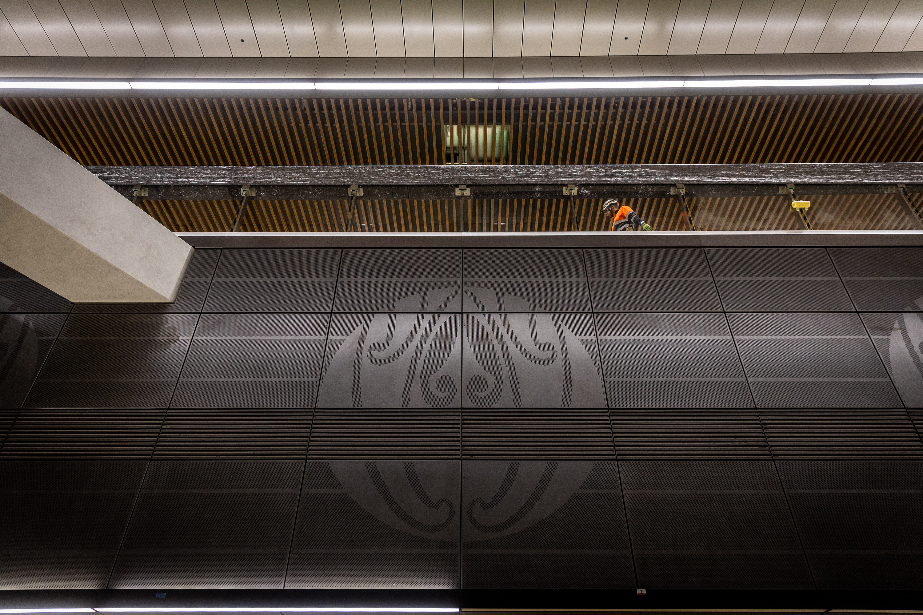 One of this country's biggest art works: circular symbols represent moving water and are on dark mesh above platforms at Te Waihorotiu Station. Photo / Michael Craig