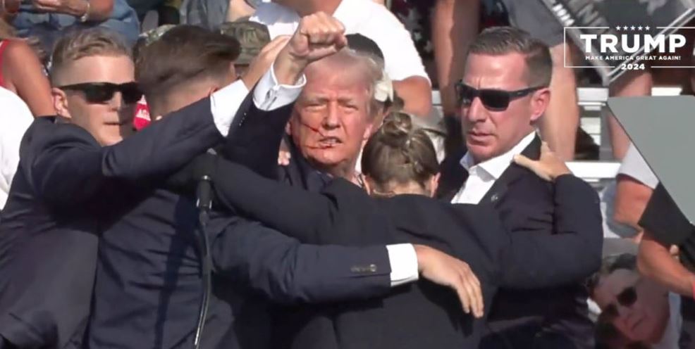 A screen grab shows Republican presidential candidate former President Donald Trump being rushed offstage after the shooting. Photo /Getty Images