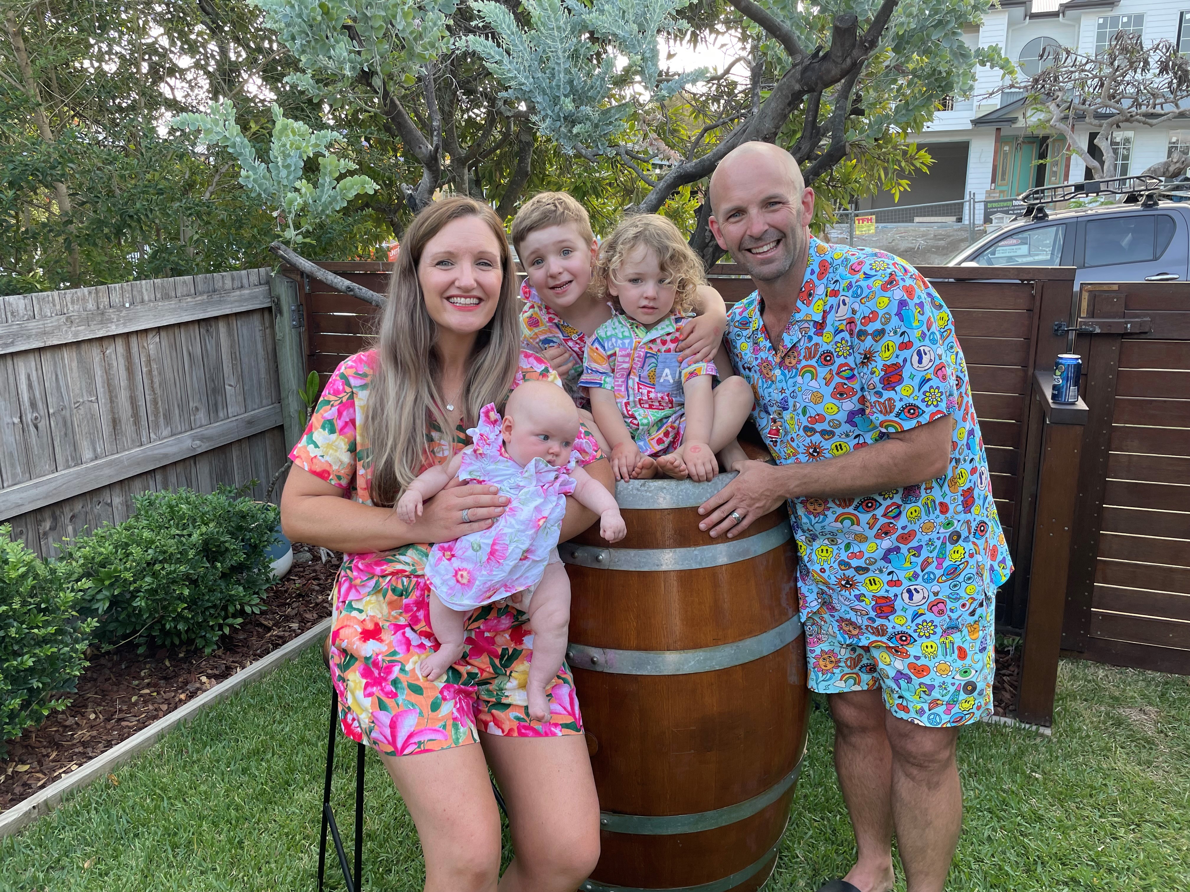 Nigel and Jules Davidson with sons Charlie, Ardie and daughter Poppy in Brisbane. Nigel says teachers enjoy better pay and conditions in Queensland.