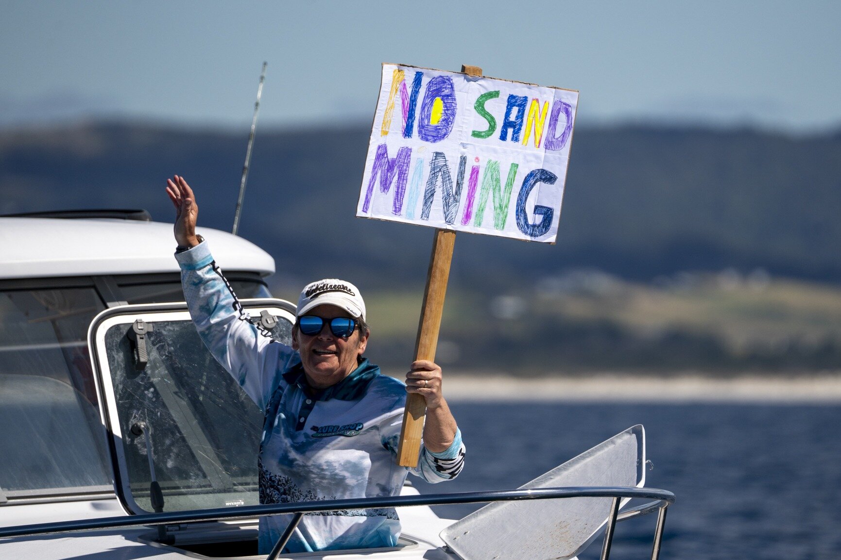 Protesters waved various signs against sand mining from their boats, against the proposal which has approval to apply for fast-track consenting. Photo / Geoff Reid

