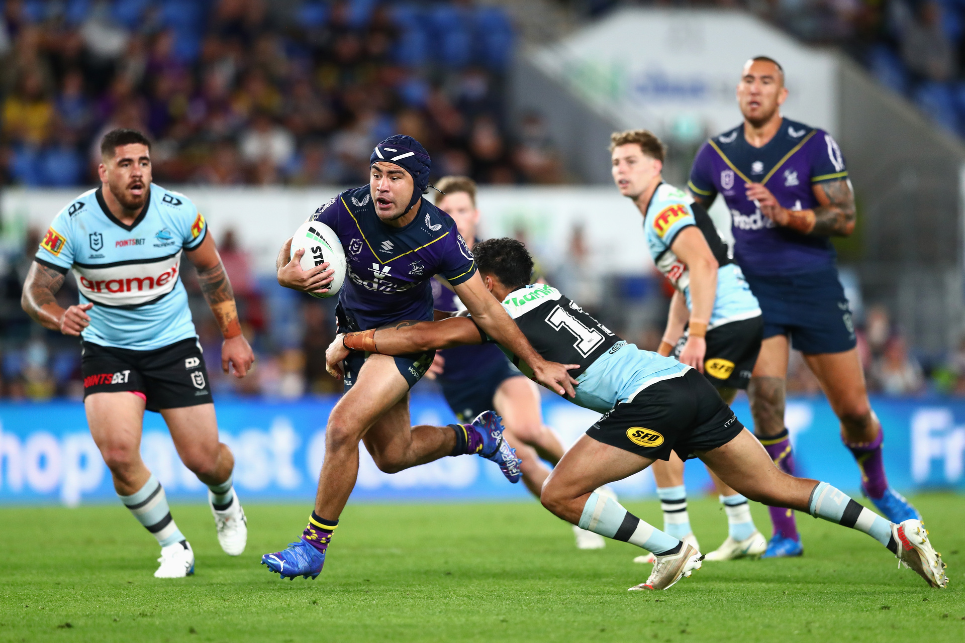 Jahrome Hughes of the Storm is tackled during the round 25 NRL match between the Cronulla Sharks and the Melbourne Storm. Photo / Getty Images.