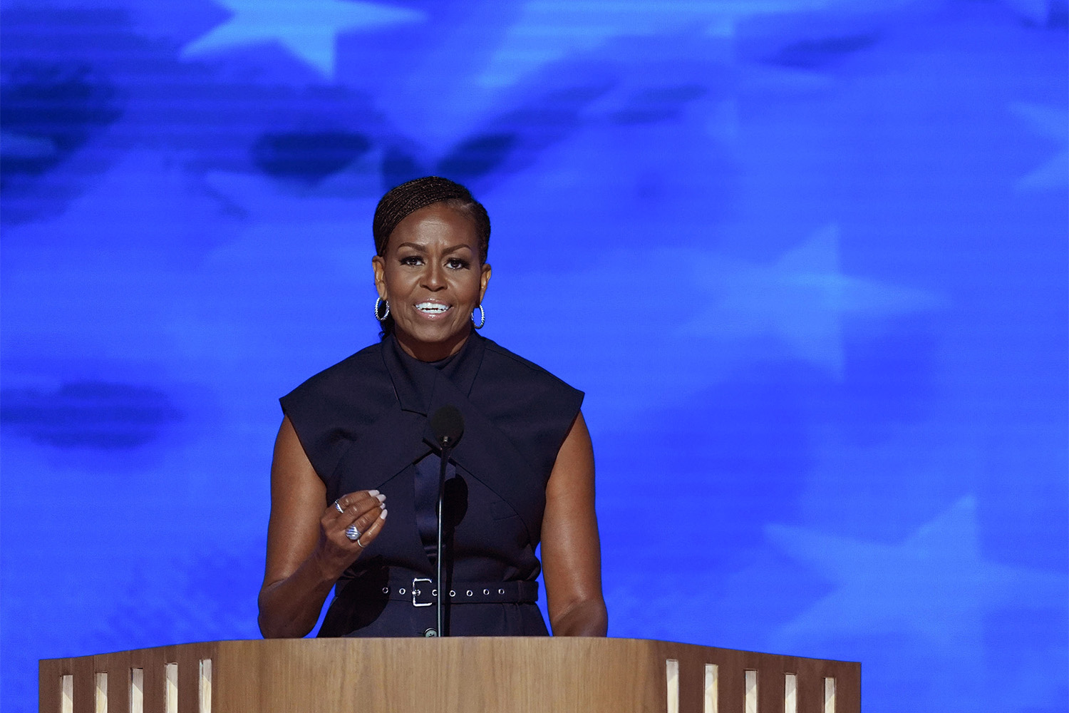 The belt on the unusual top caught the sparkle of Michelle Obama's earrings, and her fingers were stacked with jewels by David Yurman. Photo / Washington Post
