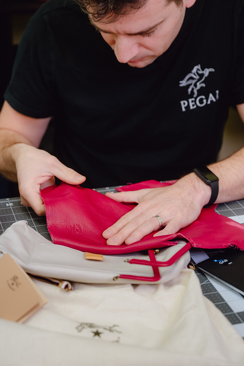 Yilmaz with an Il Bisonte leather purse he reviewed for a video. Photo / Desiree Rios, The New York Times