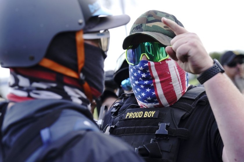 A right-wing demonstrator gestures towards a counter protester as members of the Proud Boys and other right-wing demonstrators rally in Portland, Oregon, last month. Photo / AP