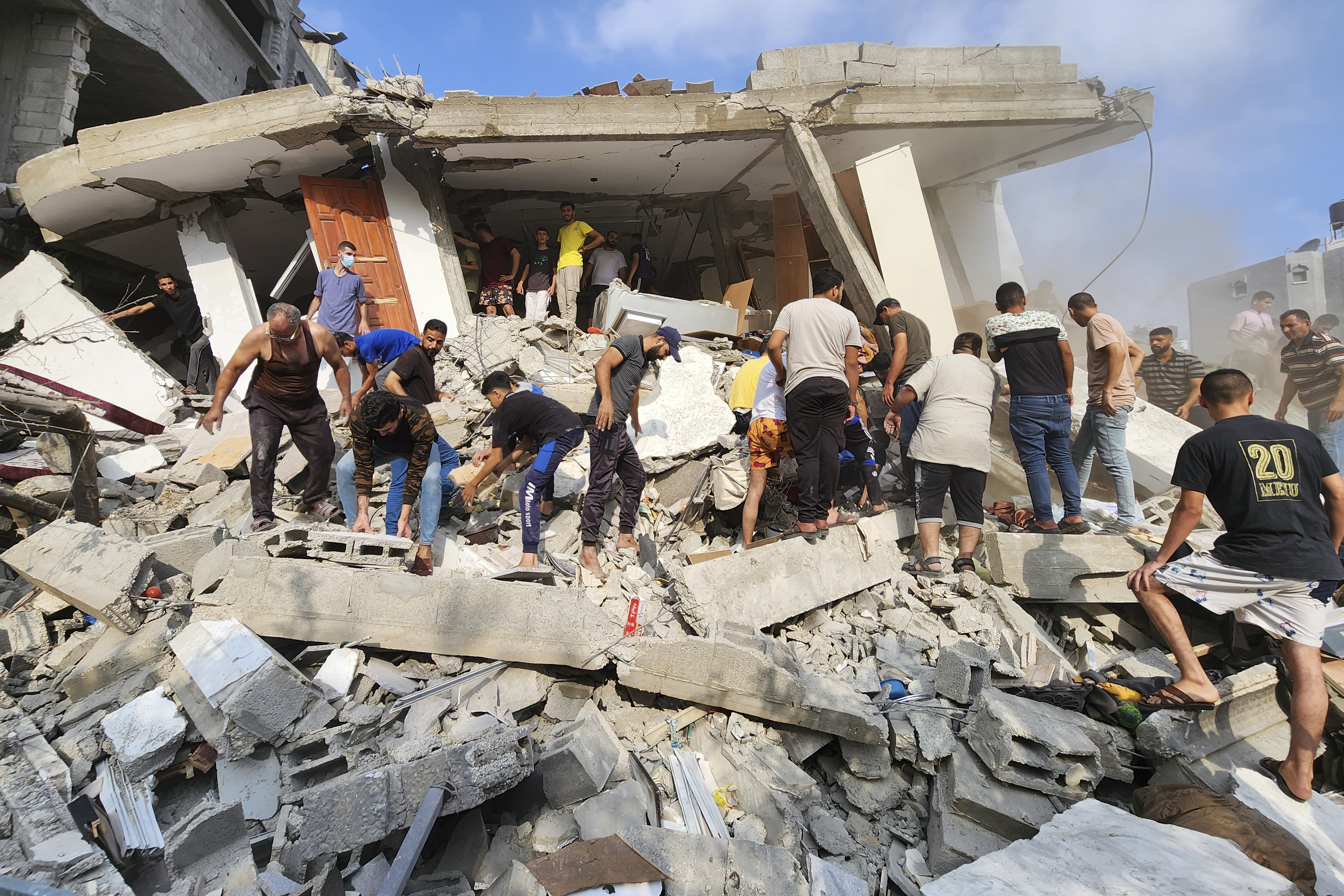 Palestinians look for survivors in the rubble of a destroyed building following an Israeli airstrike in Bureij refugee camp, Gaza Strip. Photo / AP