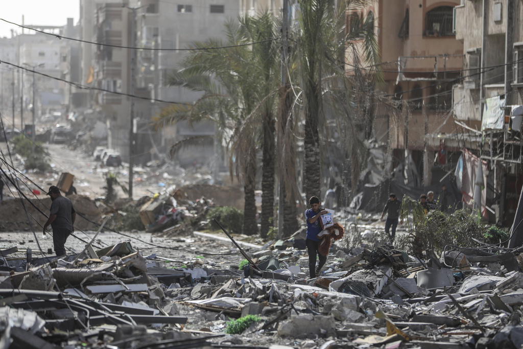 Palestinians walk through Gaza City. Photo / AP