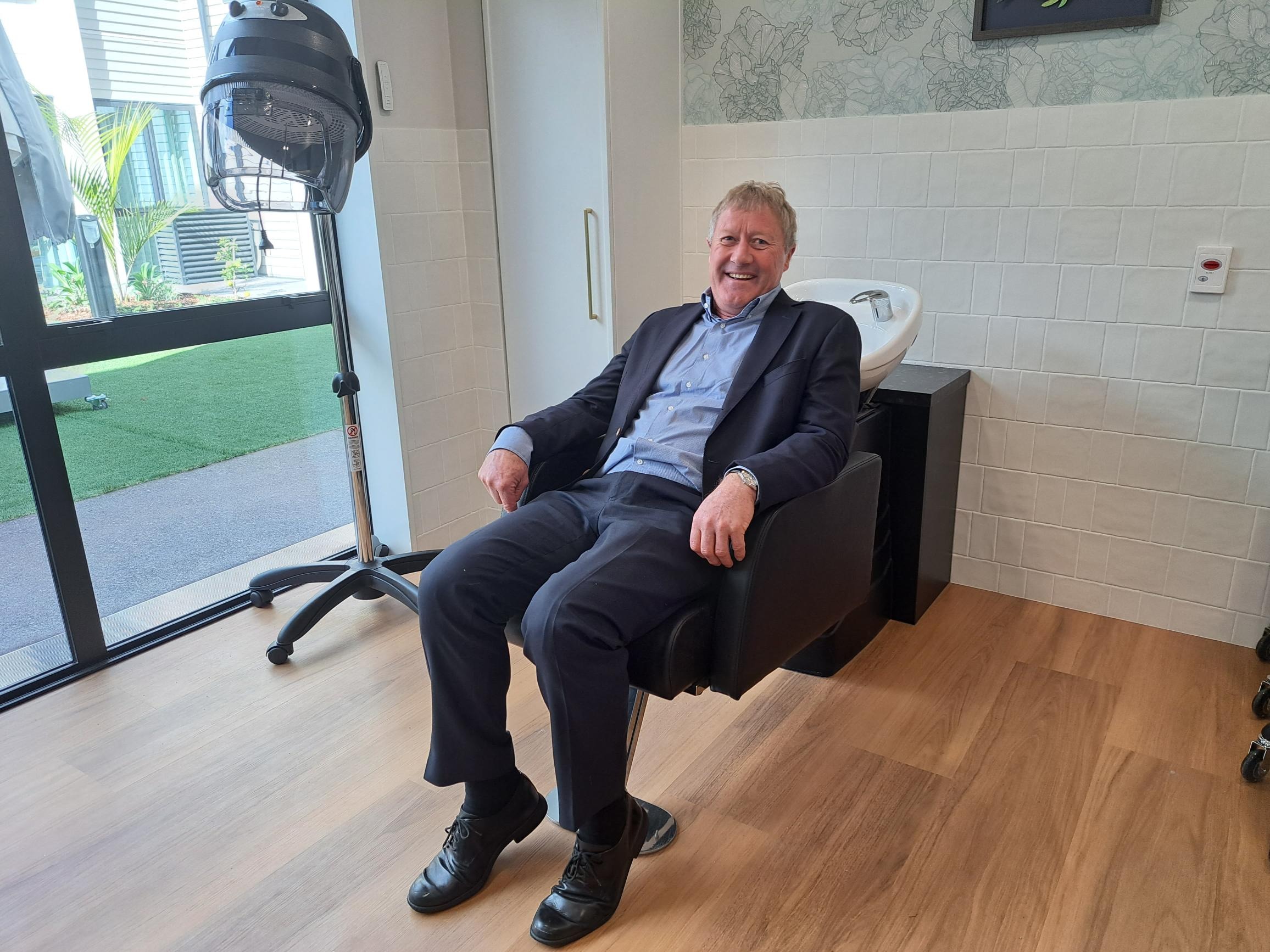 Northland MP Grant McCallum tries out the chair in the hair salon at Kerikeri’s new care home. Photo / Jenny Ling