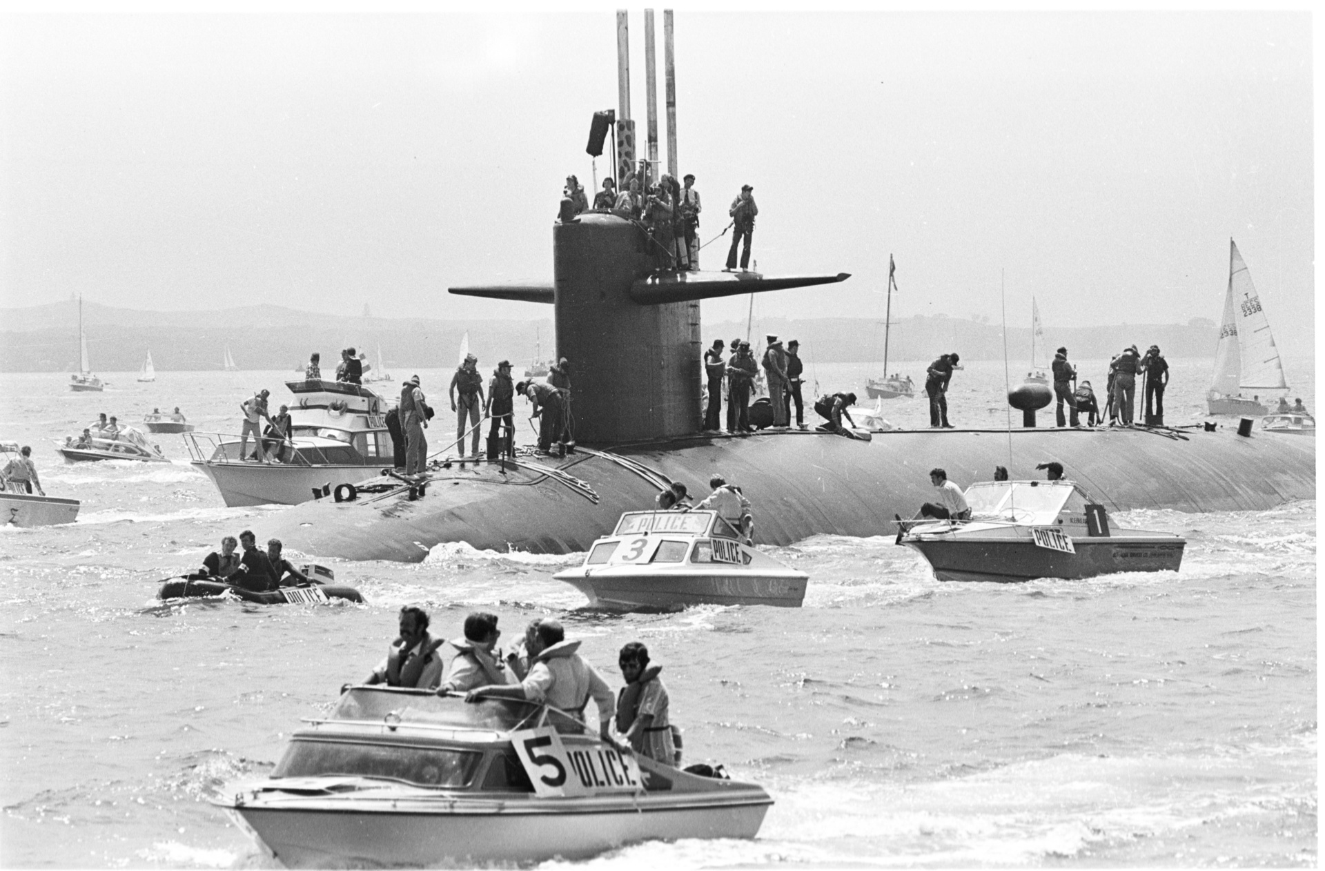 American nuclear submarine USS Haddo greeted in Auckland by numerous vessels. The flotilla was made up of police launches which acted as a barrier between the submarine and the many boats of protesters who were calling for a nuclear-free Pacific. Photo / Herald Archives
