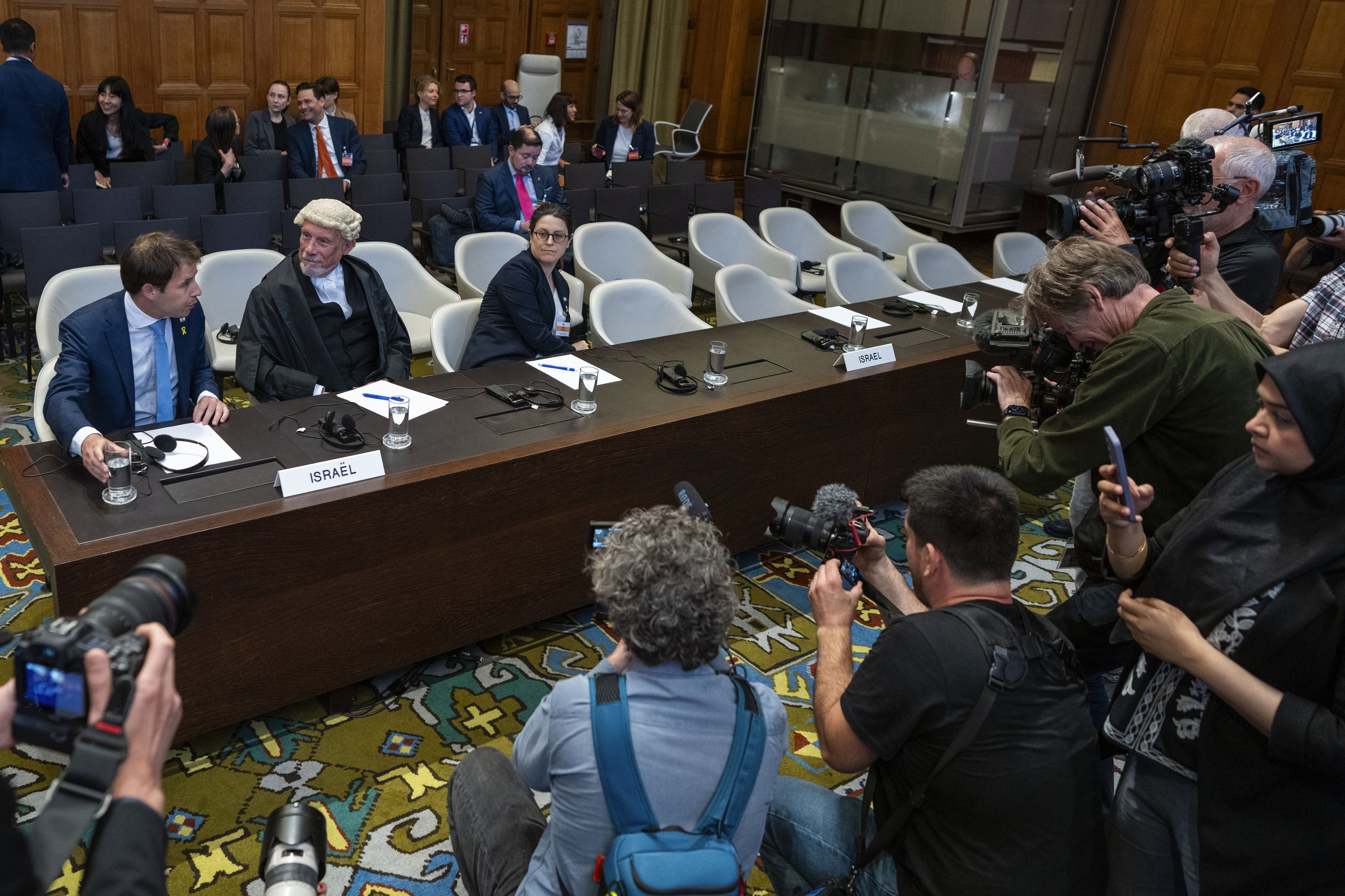 Israel's legal team, Yaron Wax (left), Malcolm Shaw and Avigail Frisch Ben Avraham, wait for judges to enter the International Court of Justice, or World Court, in The Hague, Netherlands. Photo / AP