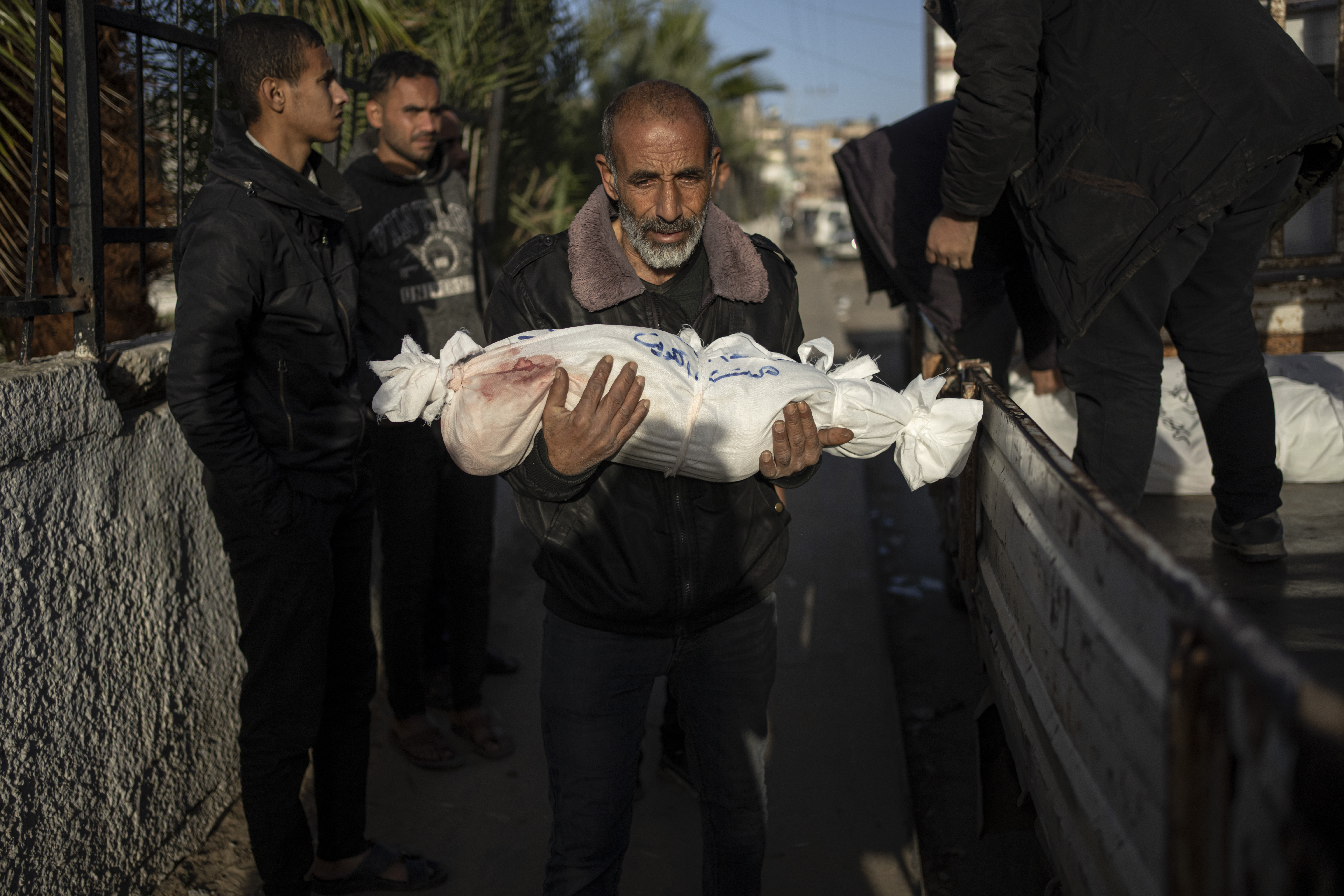 A Palestinian man carries the body of his grandson who was killed in the Israeli bombardment of the Gaza Strip. Photo / AP