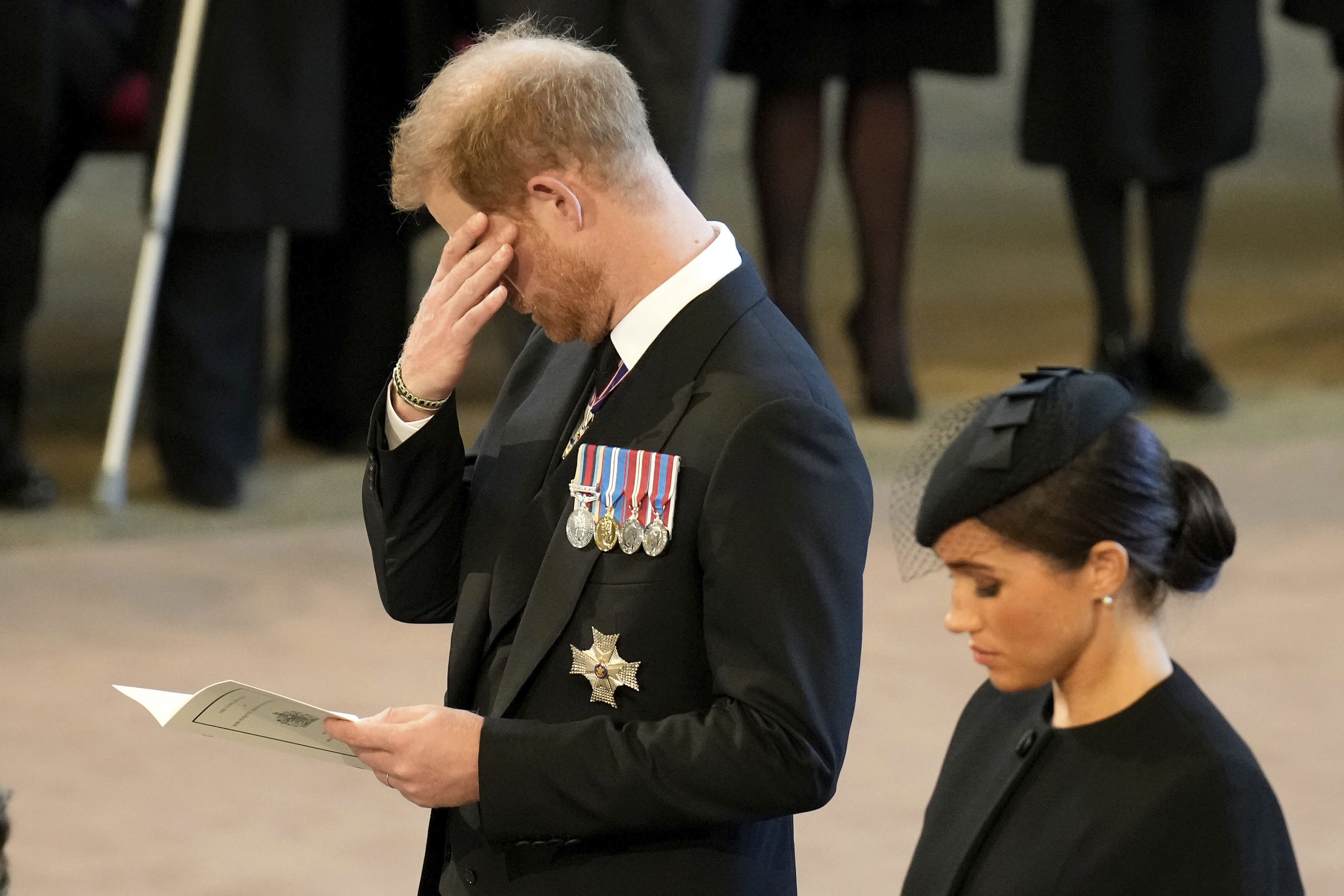 Prince Harry, and his wife Meghan, Duchess of Sussex, pay their respects to Queen Elizabeth II as the coffin rests in Westminster Hall. Photo / AP