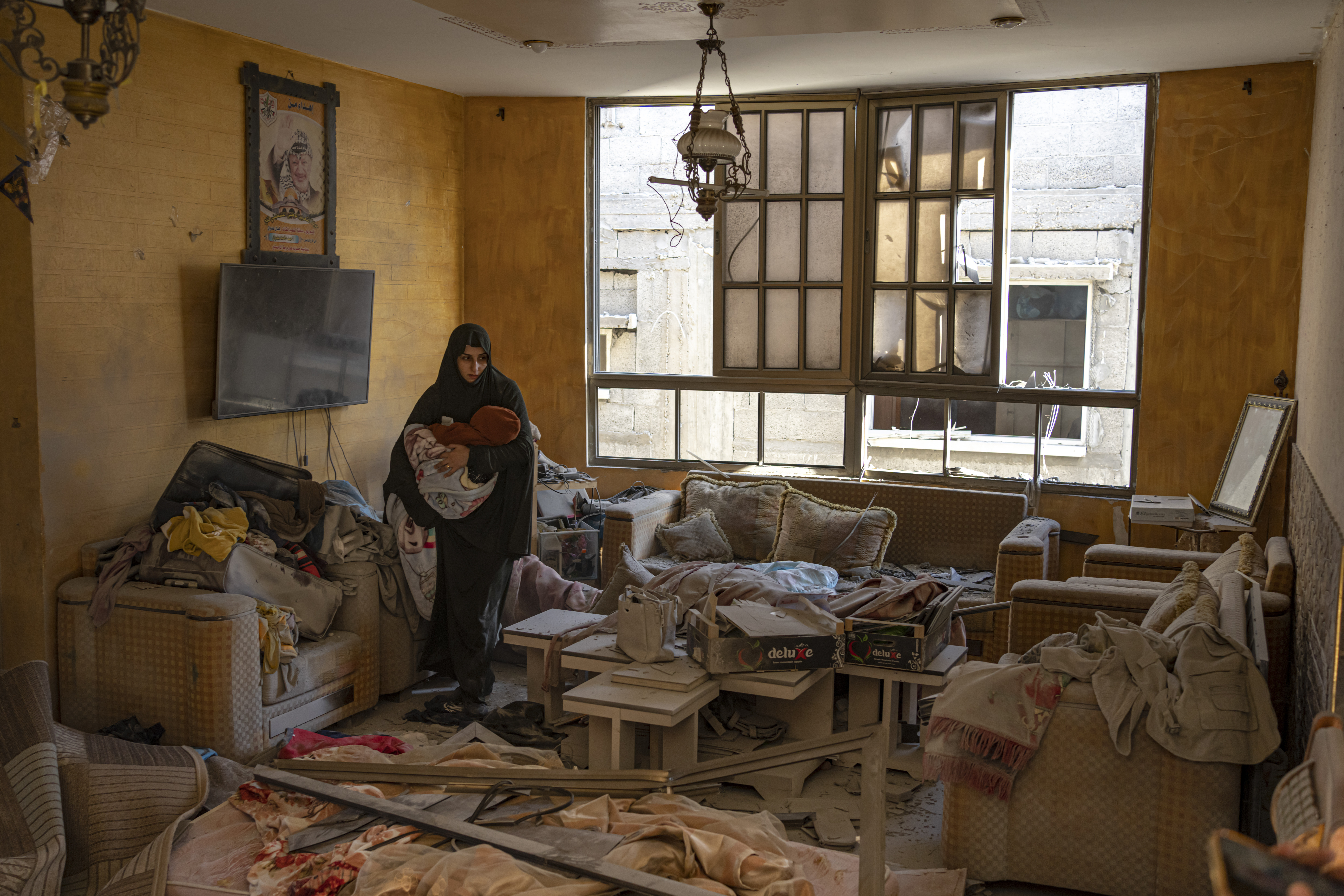 A Palestinian woman holds her child after an Israeli strike on her neighbourhood in Rafah, Gaza Strip. Photo / AP
