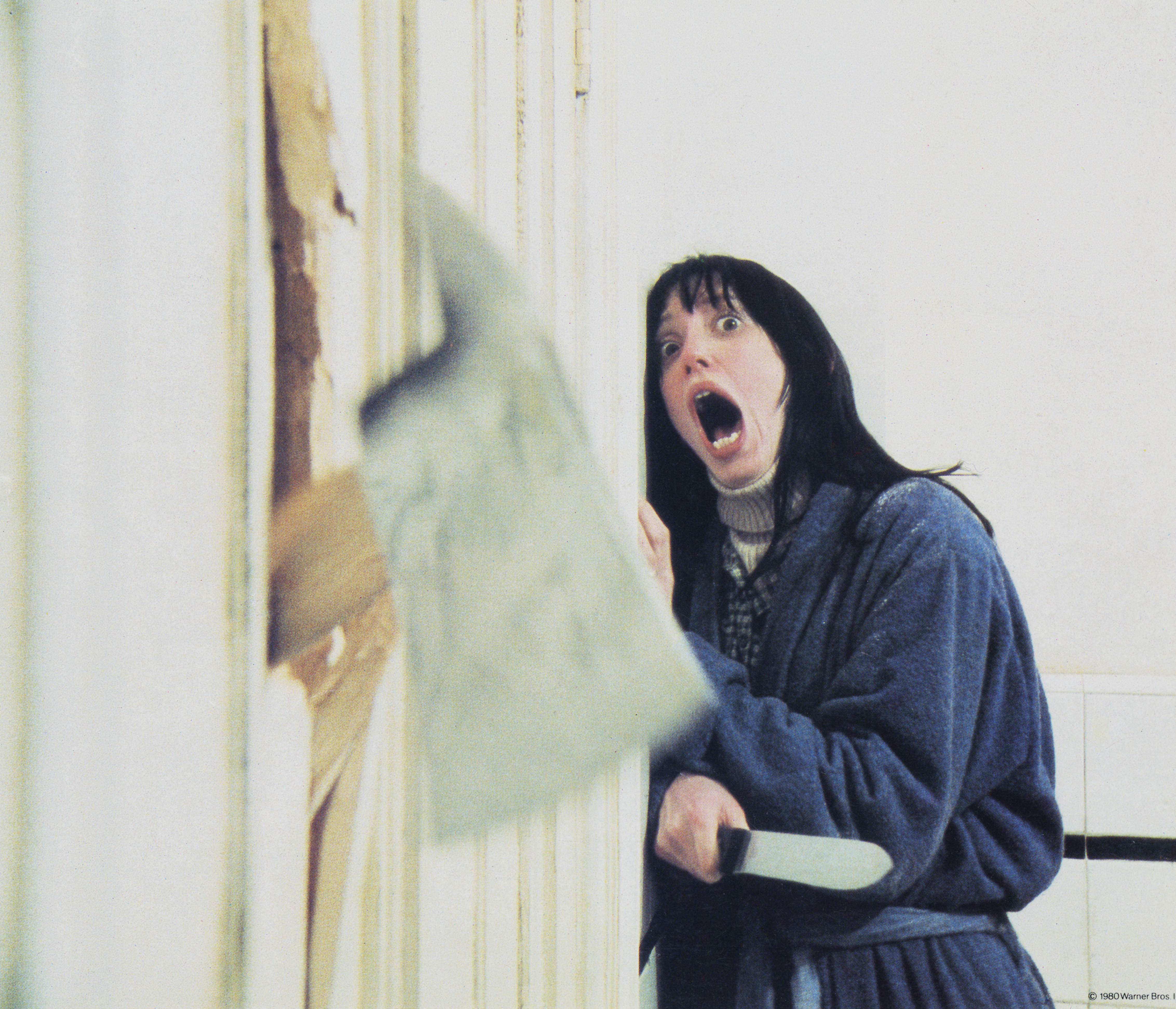 Wendy Torrance, played by American actress Shelley Duvall, recoils in shock as her husband chops through the bathroom door with a fire axe in a scene from 'The Shining.' Photo / Getty 