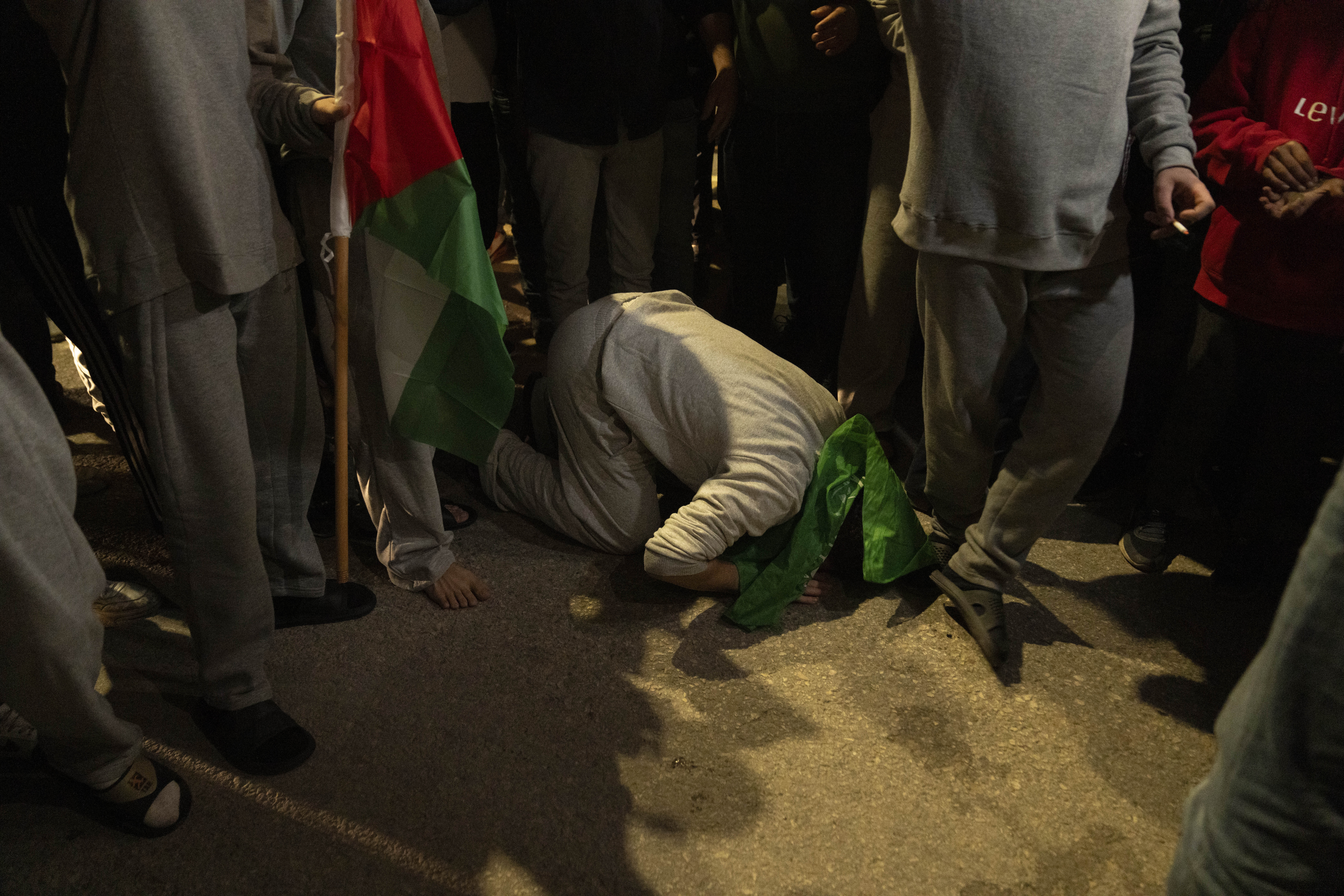 Former Palestinian prisoners who were released by the Israeli authorities, pray upon their arrival in the West Bank town of Beitunia. Photo / AP