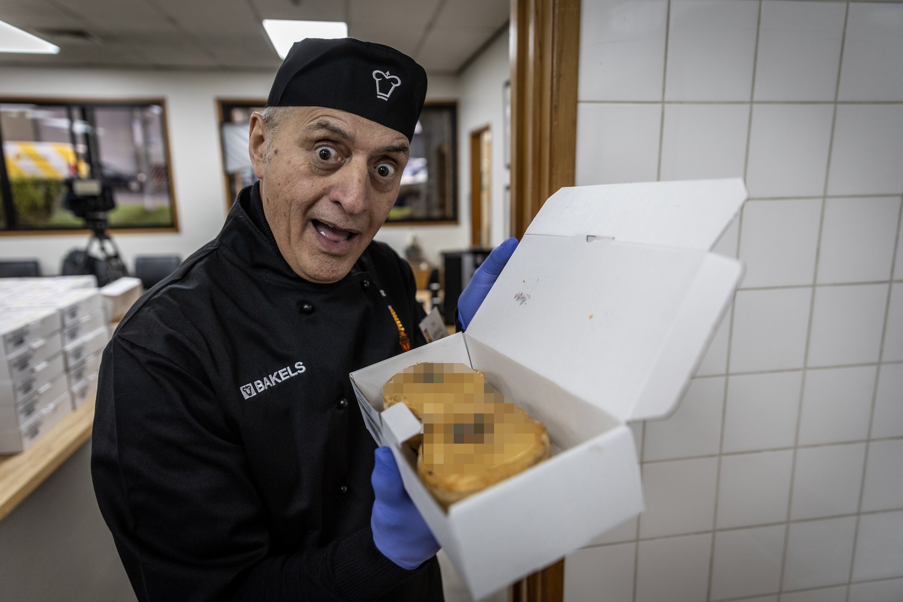Chief judge Tim Aspinall takes an entry with an unorthodox topping away for assessment. Photo / Michael Craig
