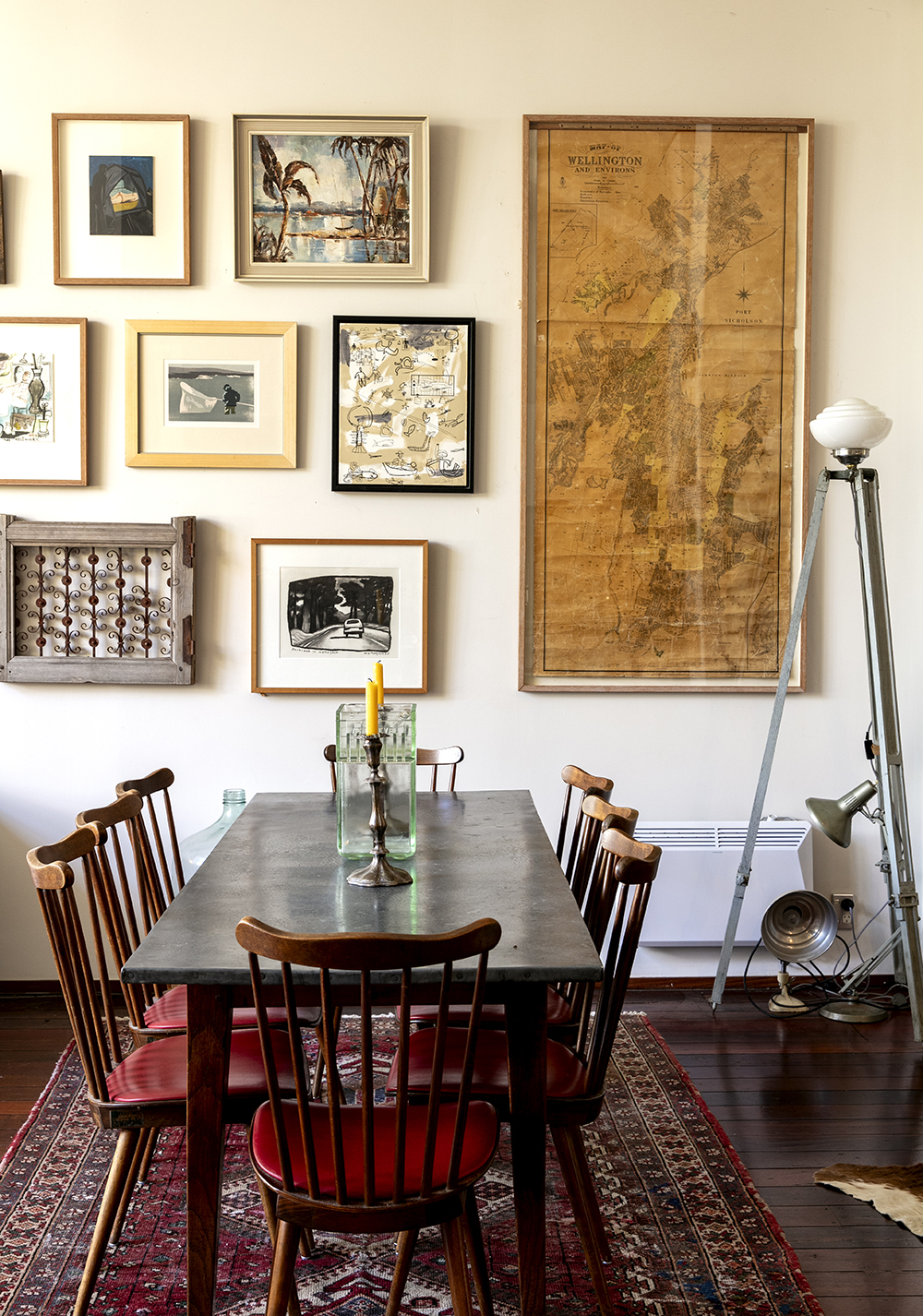 An eclectic range of artwork livens up the dining area. The dining table and chairs are from The Vitrine. Photo / Babiche Martens