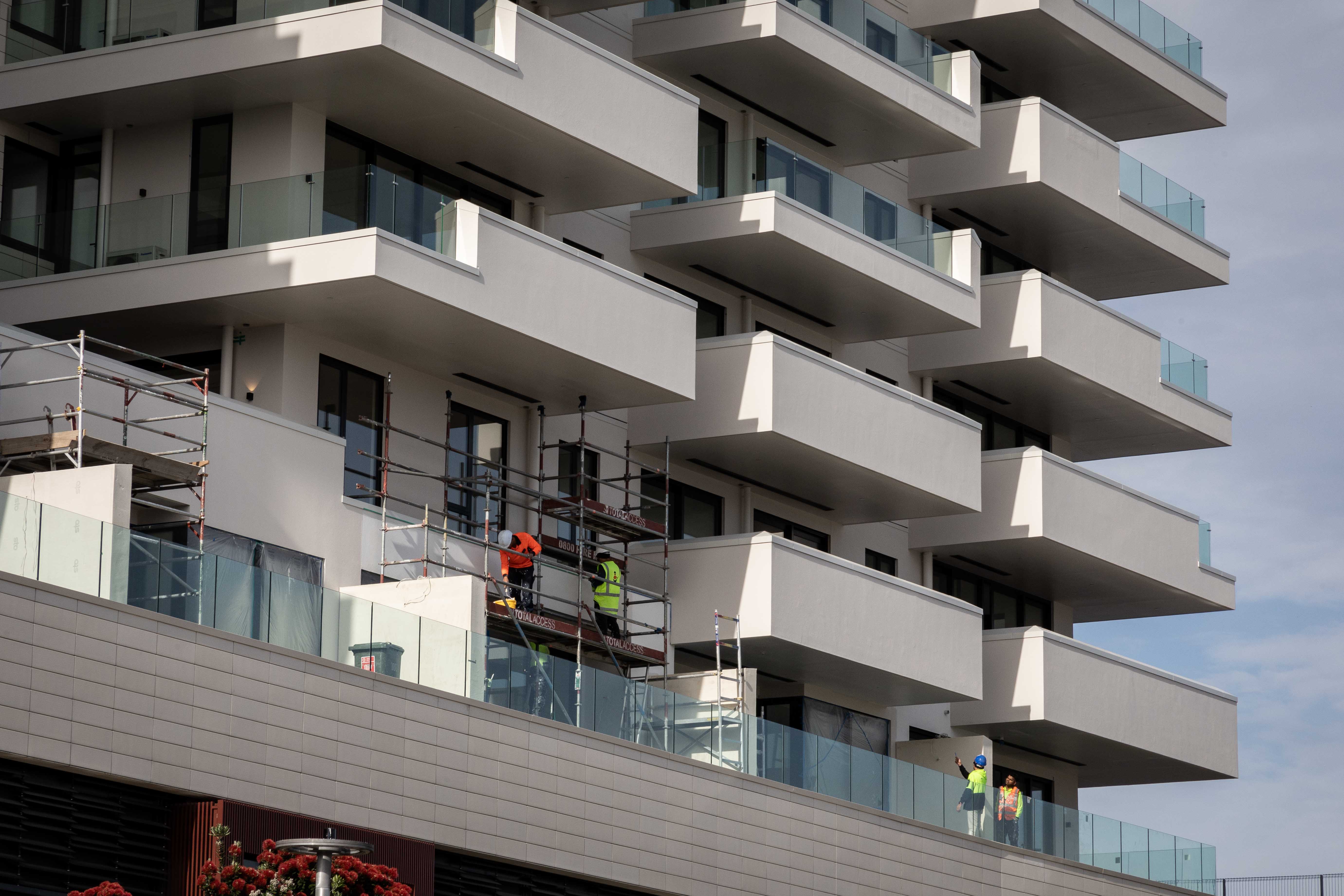 Contractors can be seen working on Elizabeth Towers, also known as the Farmers building, on Devonport Rd. Photo / Alex Cairns