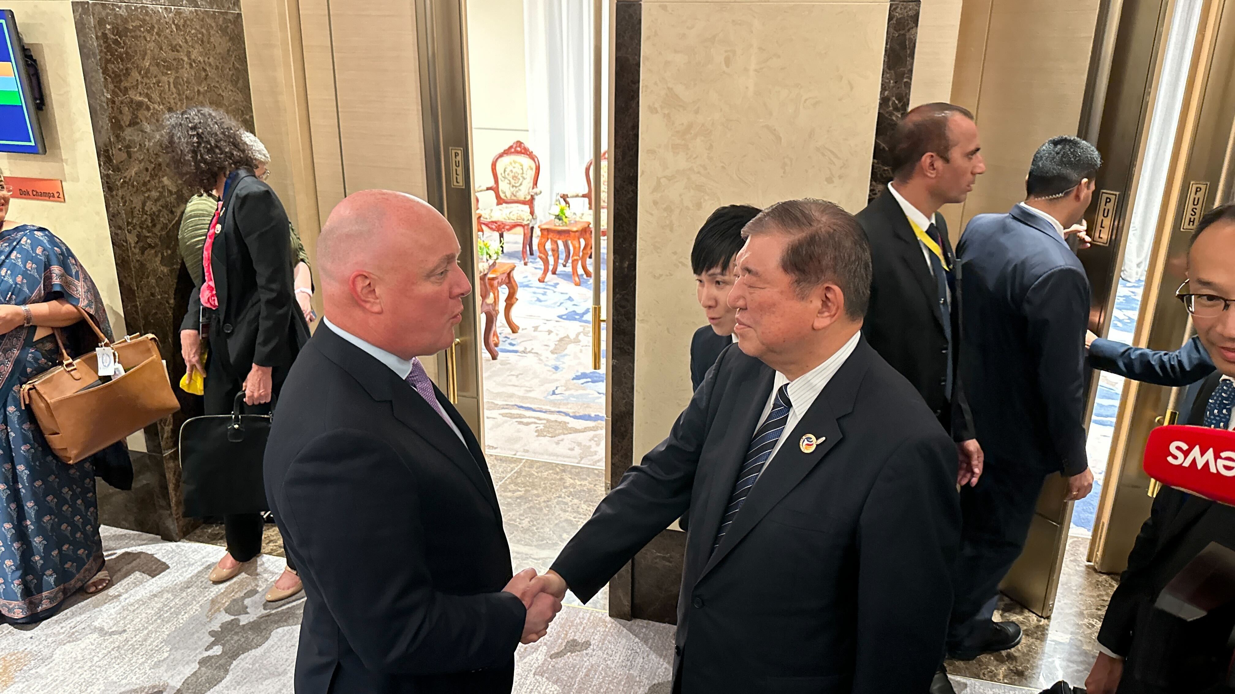 Prime Minister Christopher Luxon briefly speaks with Japan's new leader Shigeru Ishiba. Photo / Jamie Ensor