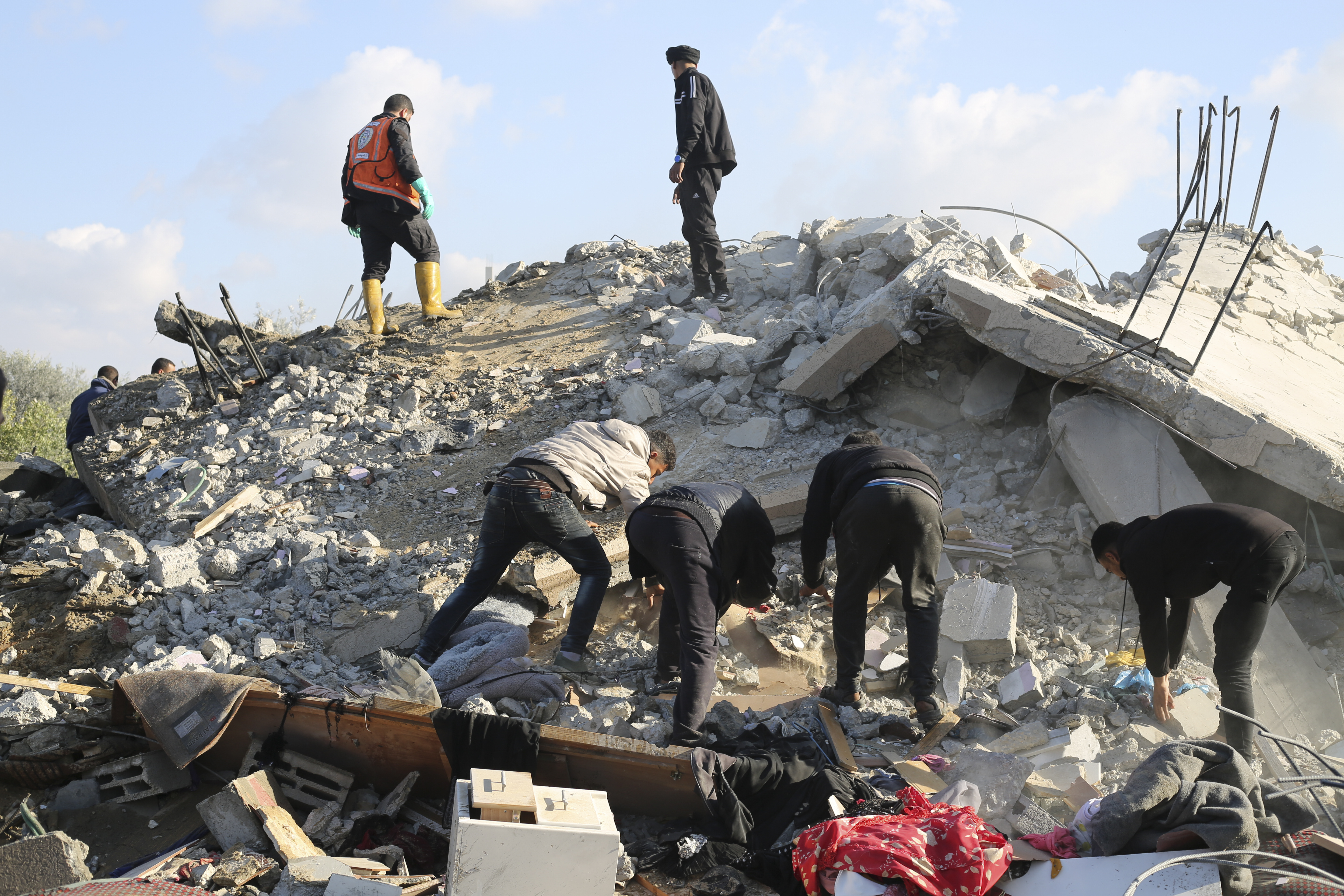 Palestinians search for survivors after an Israeli airstrike on a residential building In Rafah. Photo / AP
