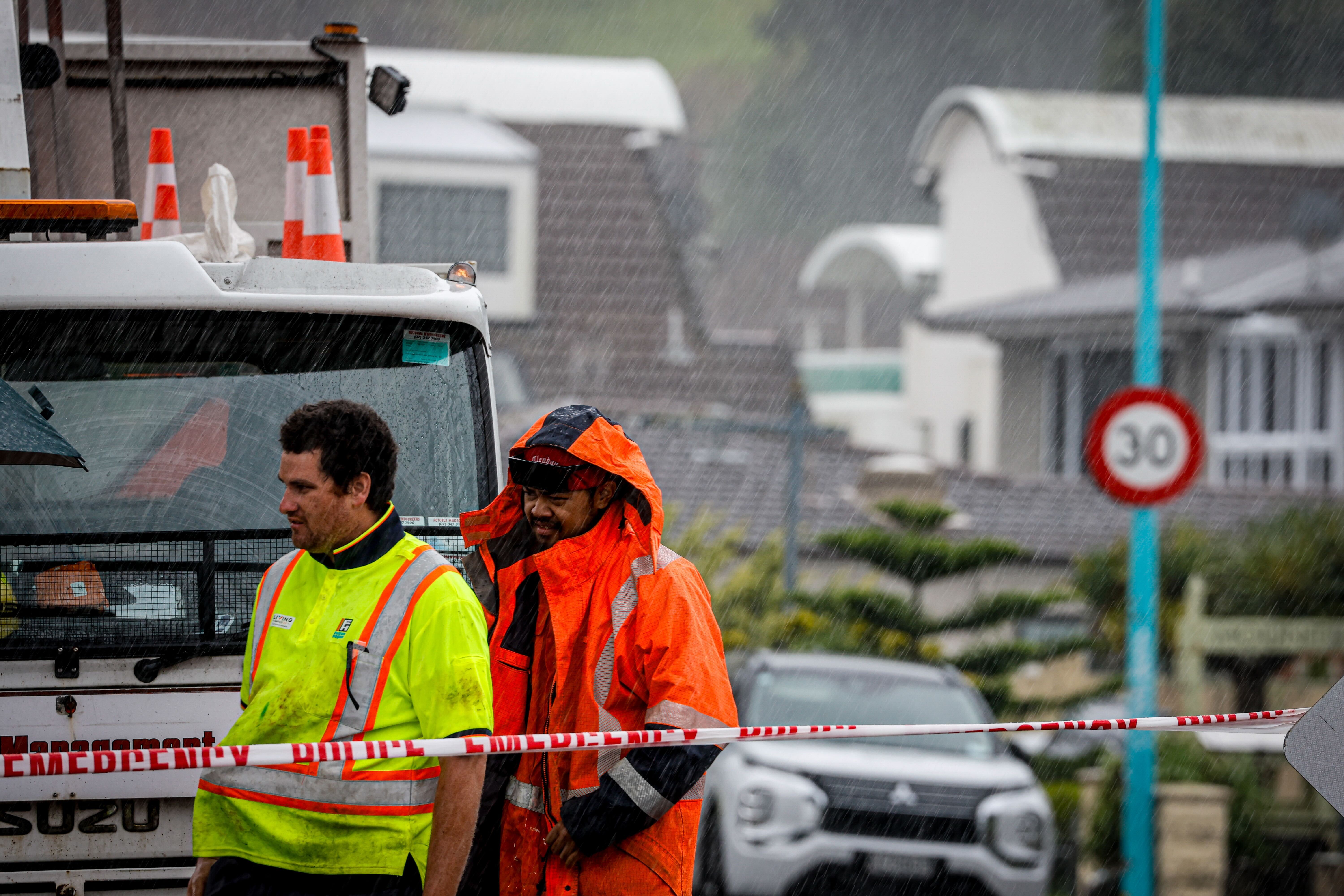 An intense burst of rain swept through Mount Maunganui at 6pm, drenching roadworkers manning the cordon at The Mall. Photo / Michael Craig
