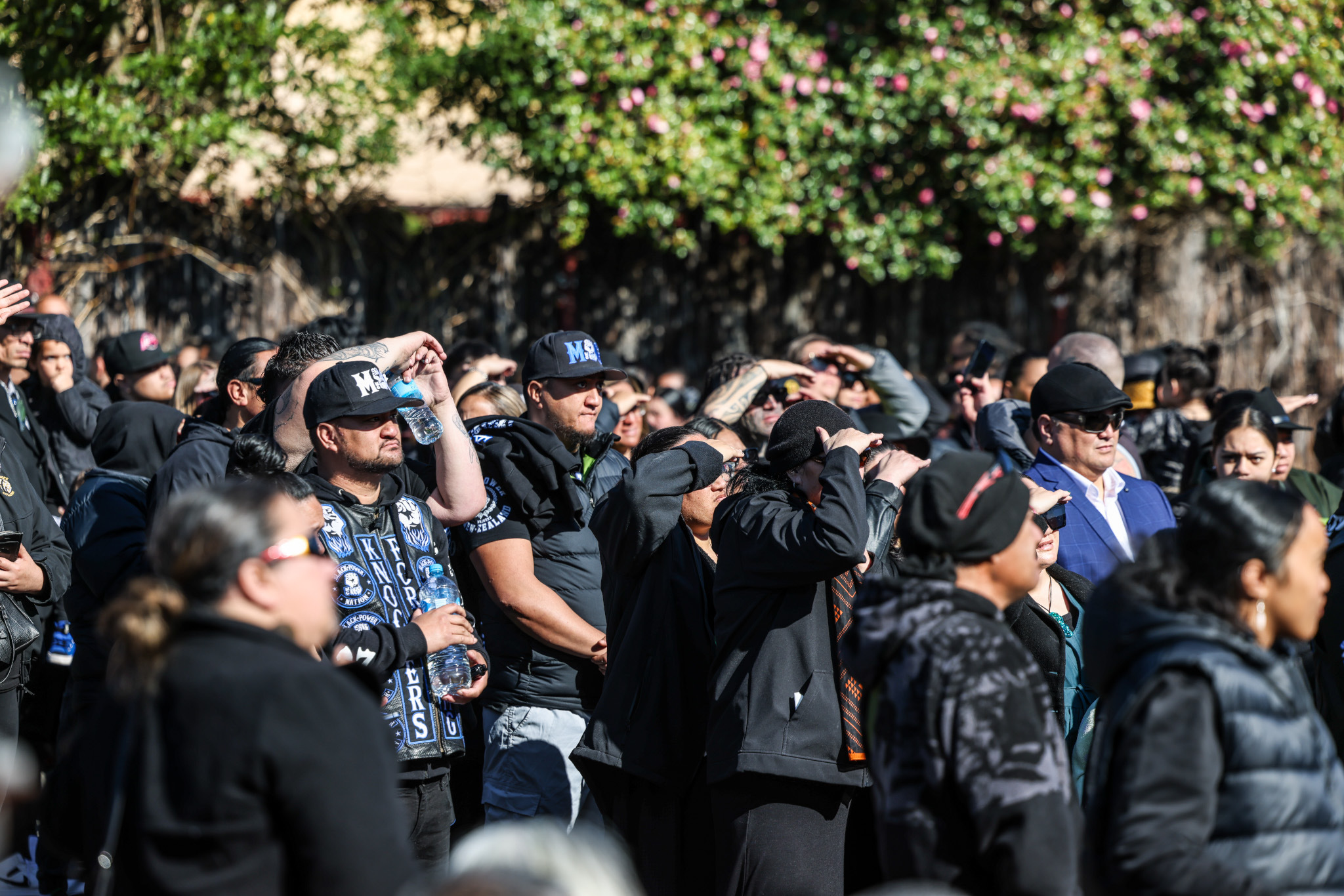 Large crowds gathered on the road outside the marae watched the anointment of new Māori monarch on a large screen. Photo / Mike Scott