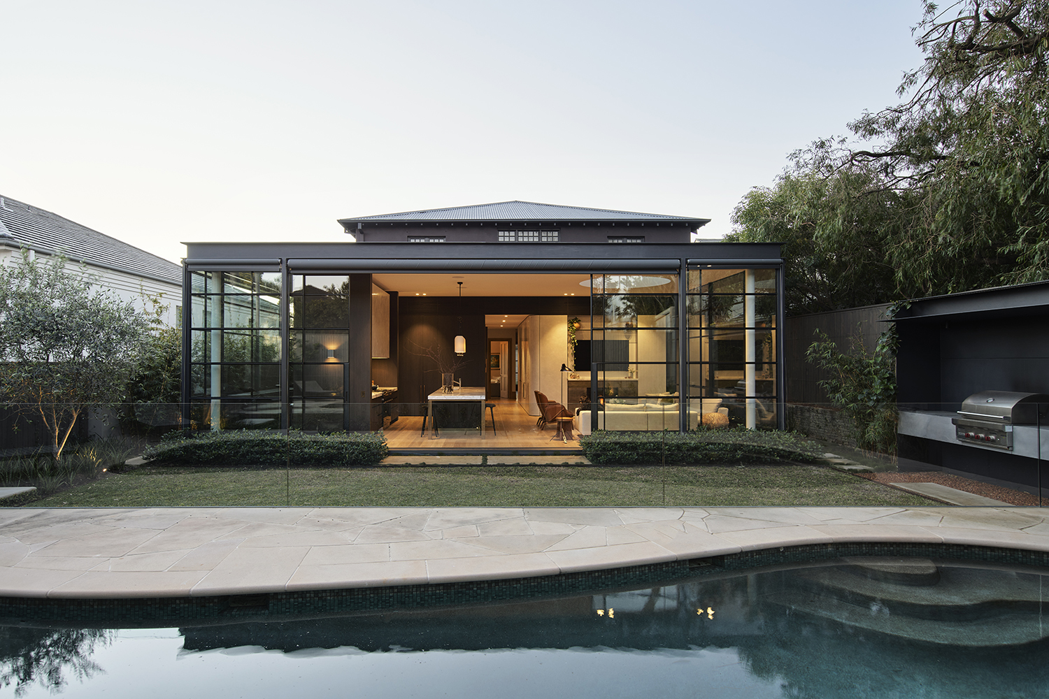 The east-facing pool area on the south side is awash with calming light yet protected from the harsh Sydney sun, its steel and glass extension linking indoors and out. Photo / Supplied