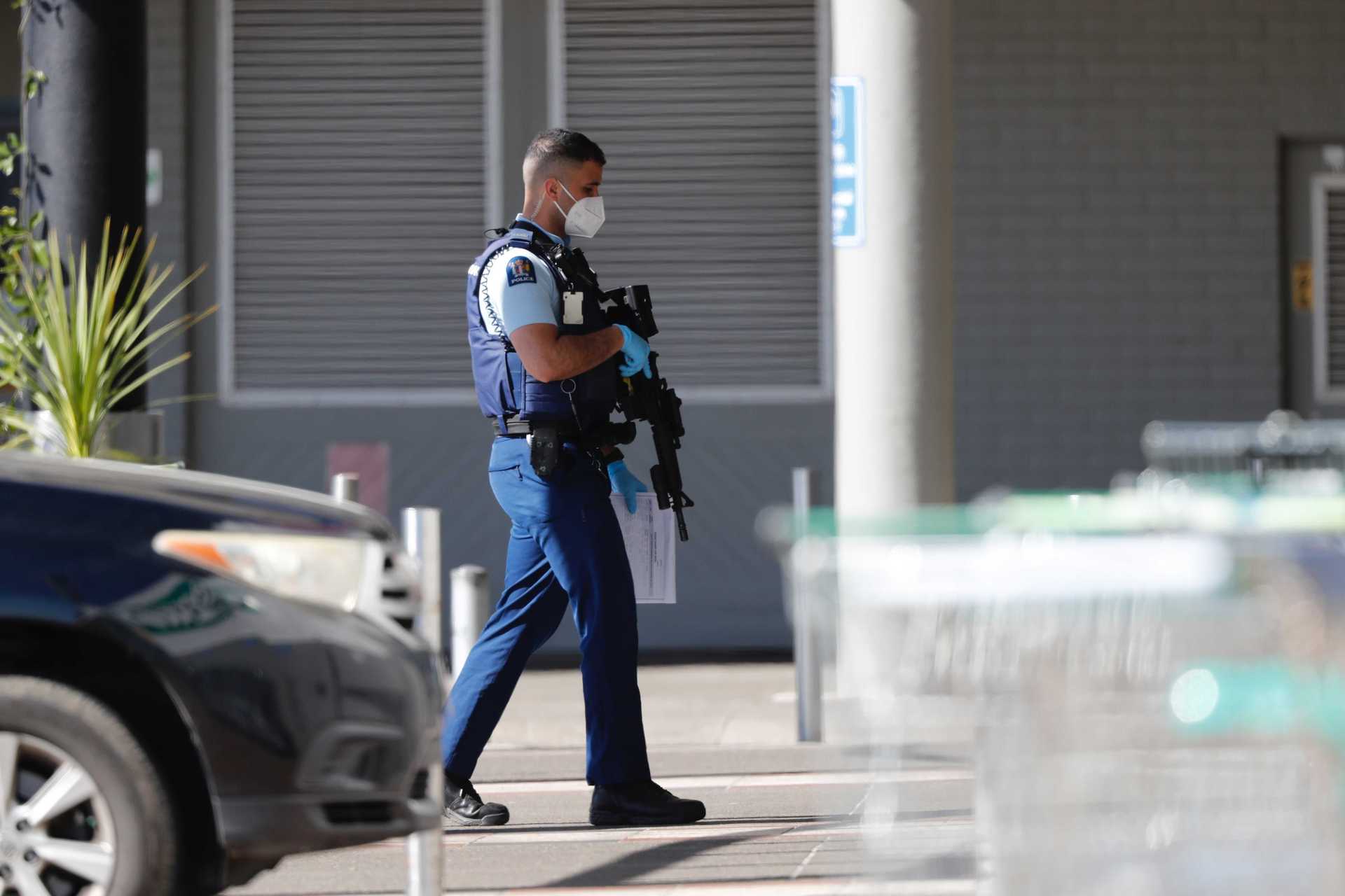 Armed police remain at the New Lynn mall terrorism attack today, a day after six people were attacked by a terrorist shot dead by police. Photo / Dean Purcell