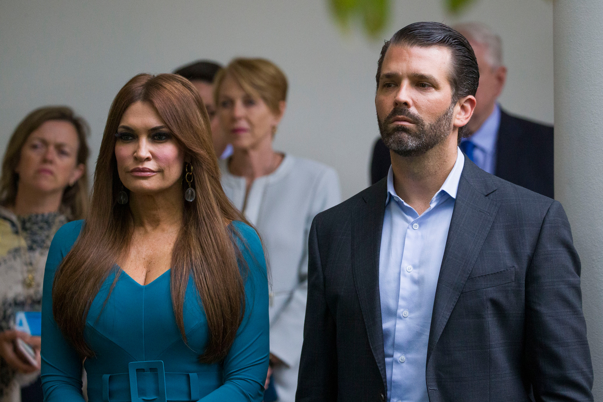 Donald Trump Jr., the son of President Donald Trump, right, and his girlfriend Kimberly Guilfoyle, listen as President Donald Trump speaks. Photo / AP